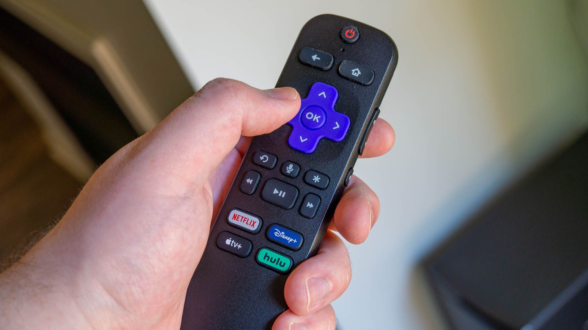 Person holding a Roku remote