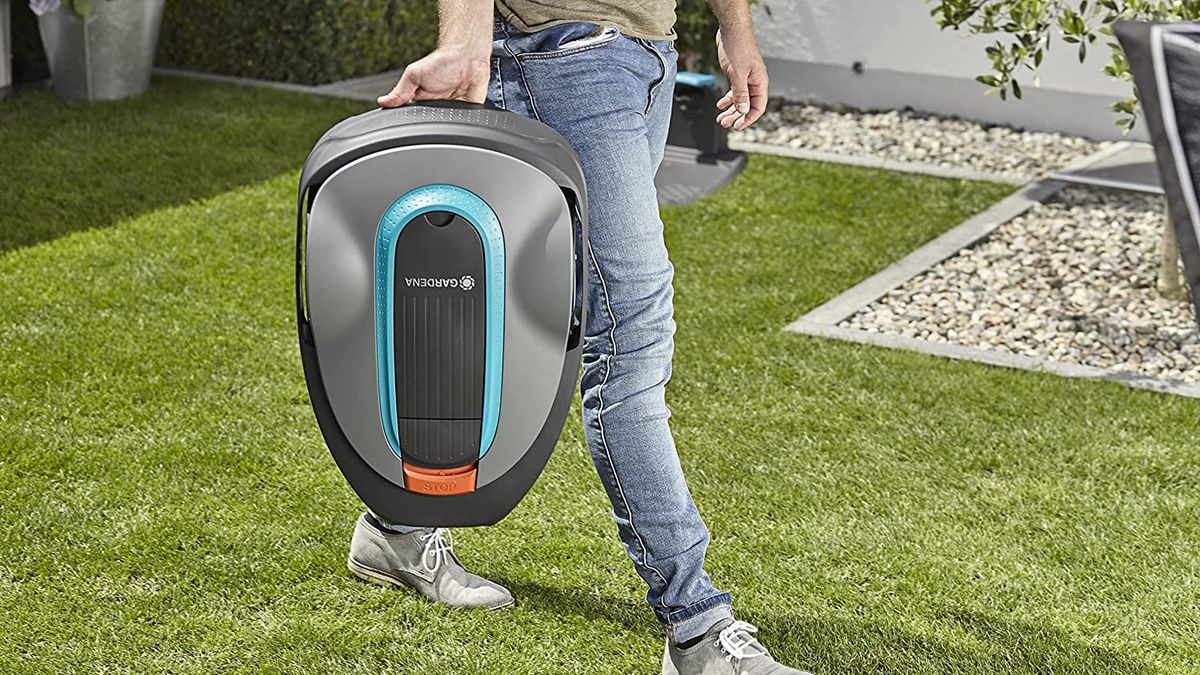 Person carrying Gardena robot lawn mower