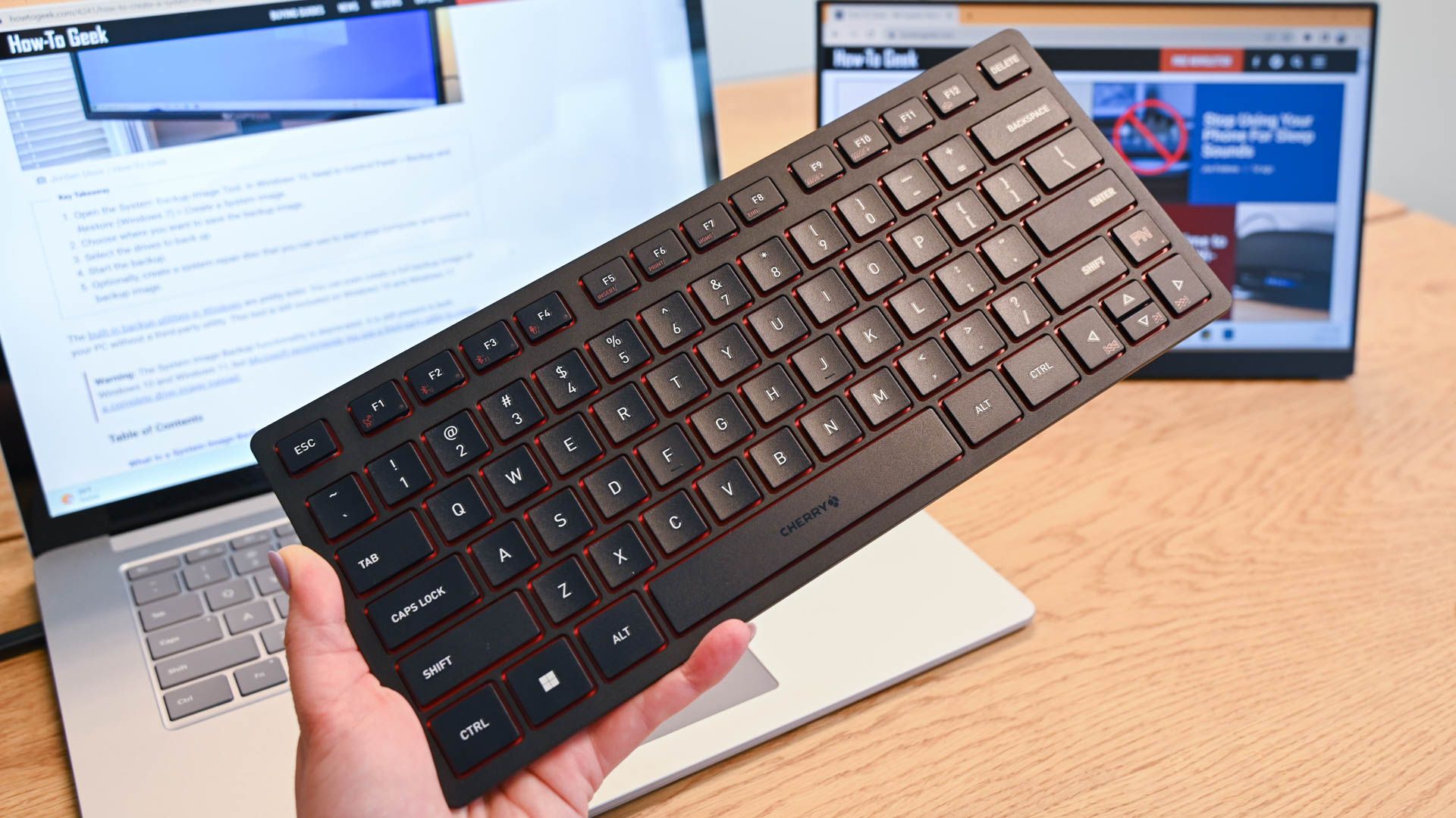 Person holding the Cherry KW 9200 Mini Keyboard