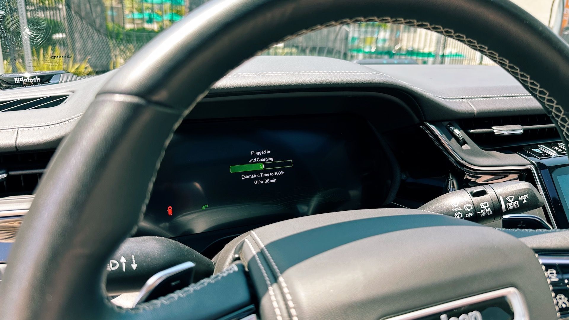 A view of the driver's instrument cluster screen looking through the steering wheel
