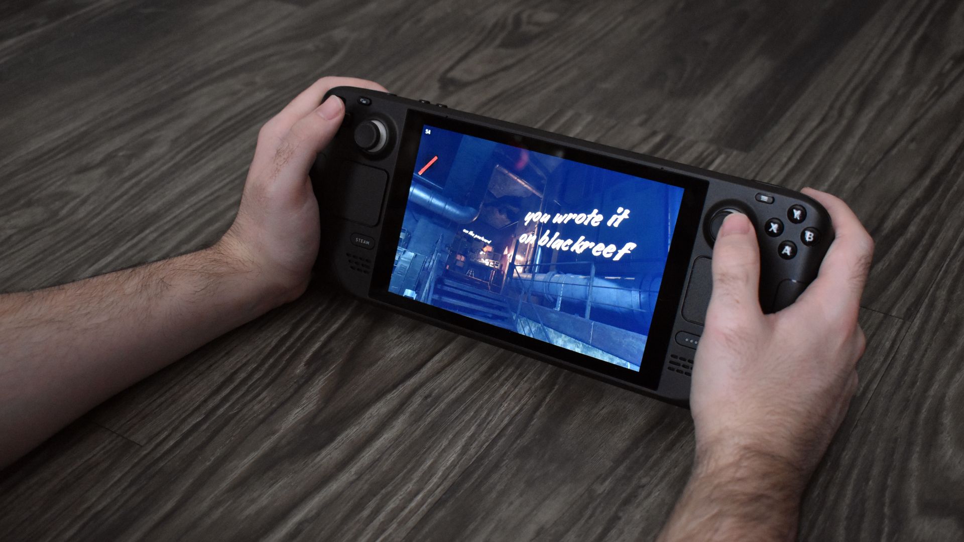 Person holding the Steam Deck and playing a game