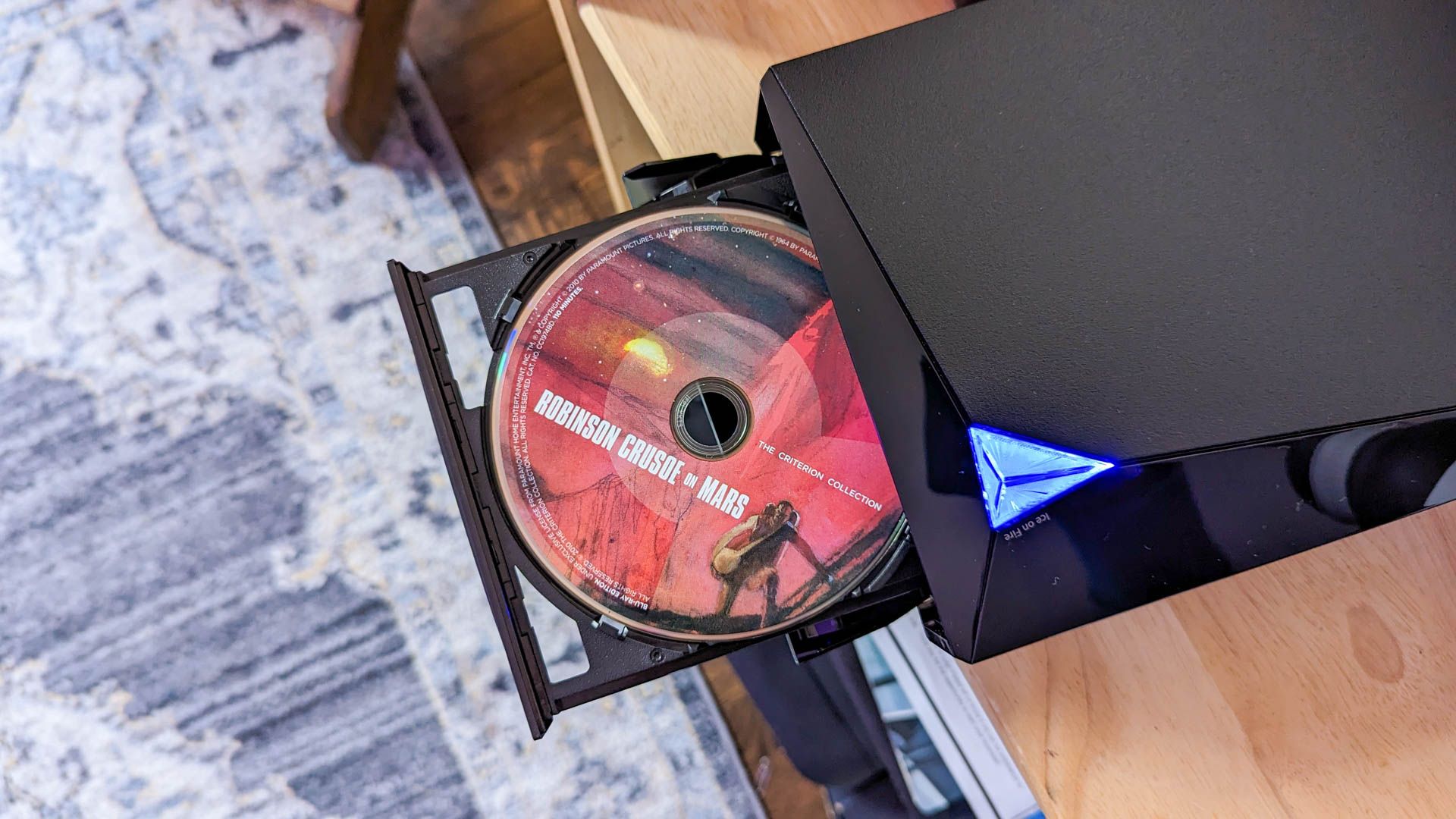 An ASUS BW-16D1X-U external Blu-ray disc reader with a disk inside