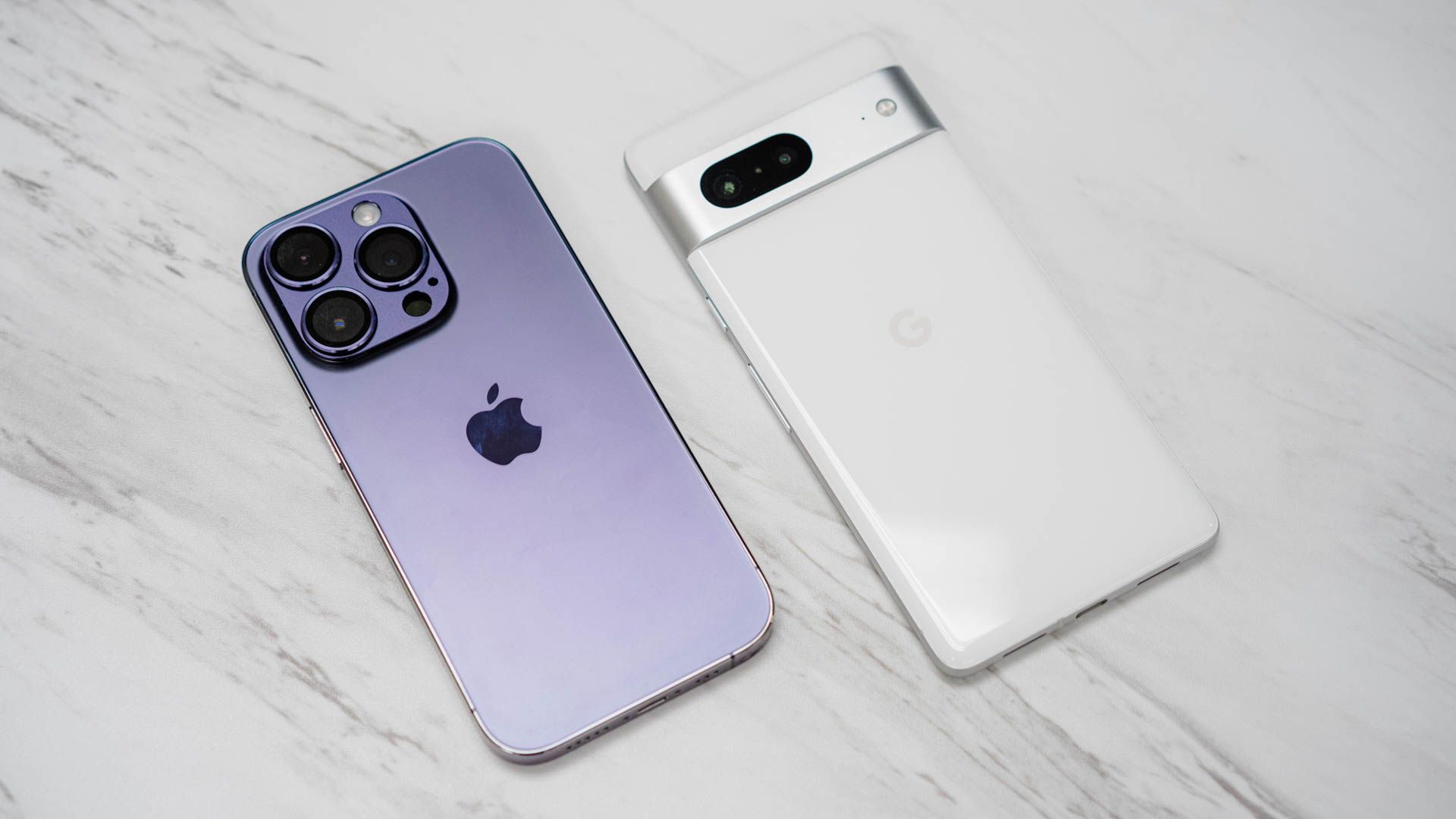 An iPhone 14 Pro and a Google Pixel 7 laid next to each other
