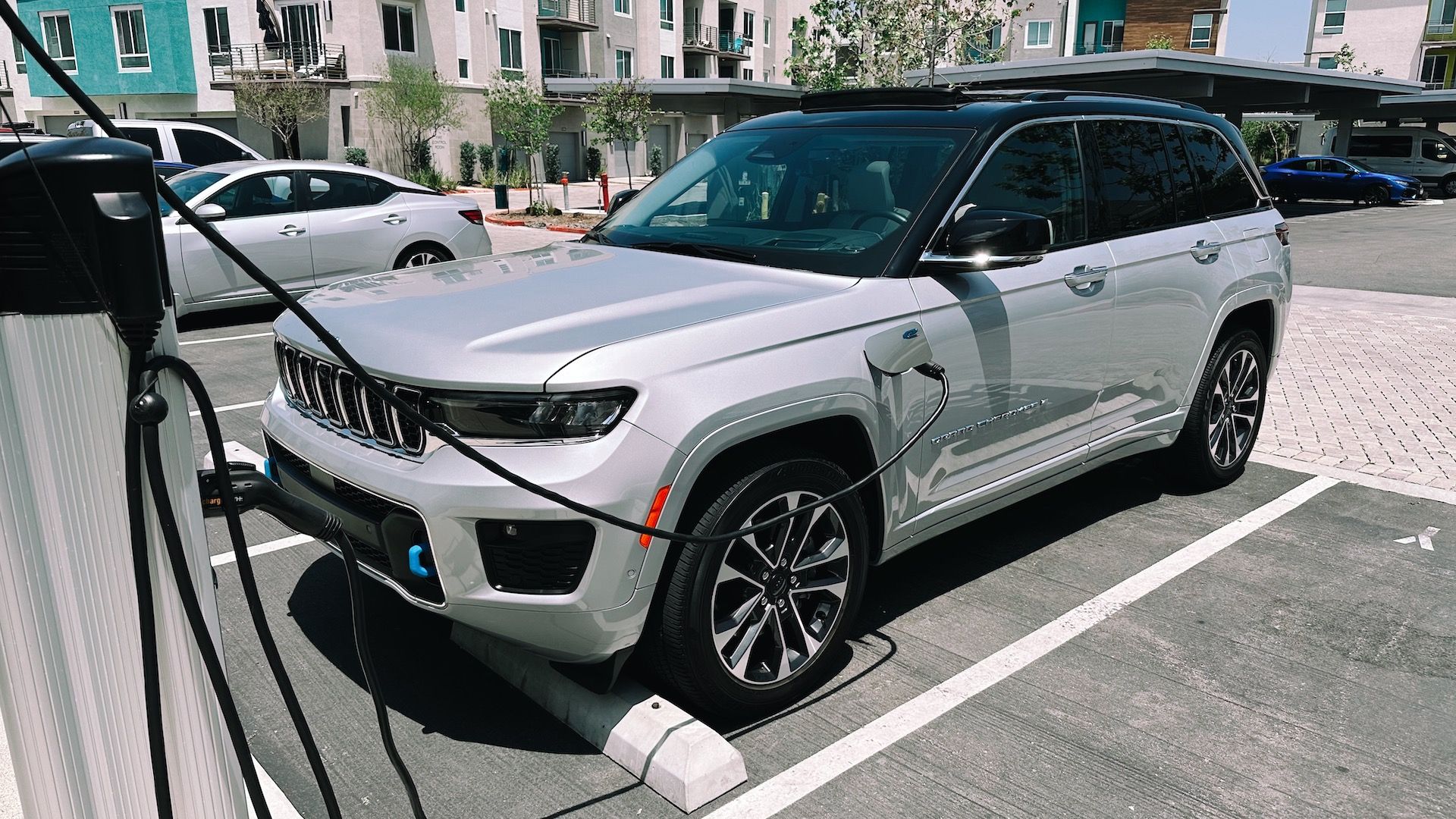 Showing the Grand Cherokee 4xe plugged into a public charging station