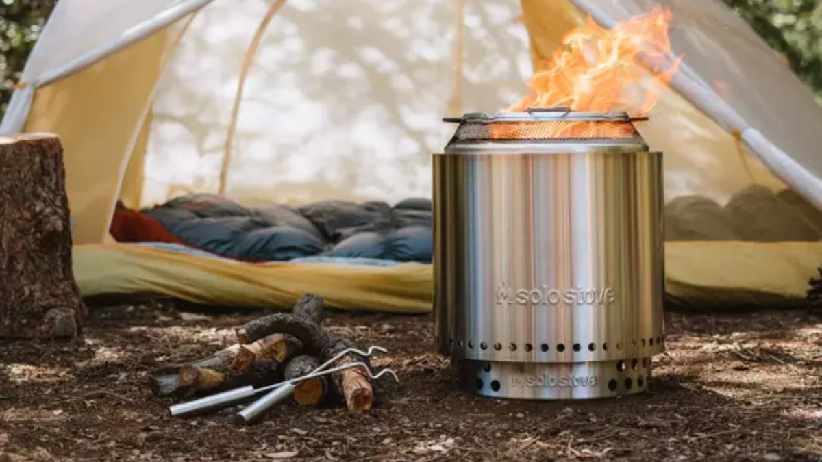 A Solo Stove backyard Bundle in the wilderness near a tent