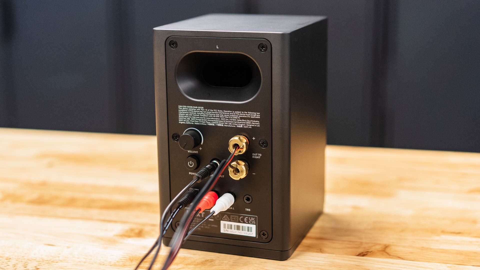 Wires hooked up to the back of a NZXT Relay Speaker.