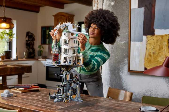 Someone adjusting the LEGO Gringotts Wizarding Bank kit.