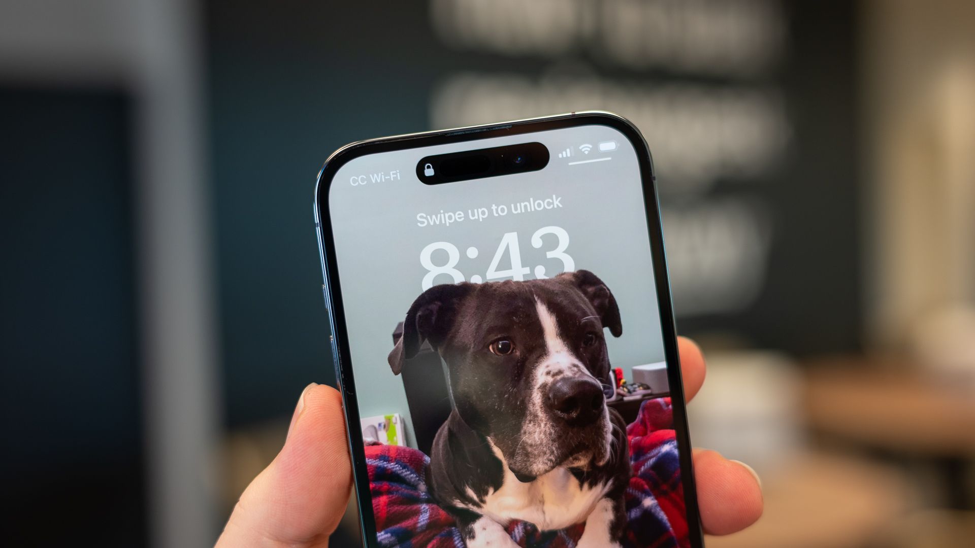 Apple iPhone 14 Pro&rsquo;s lock screen clock interlaced with a photo