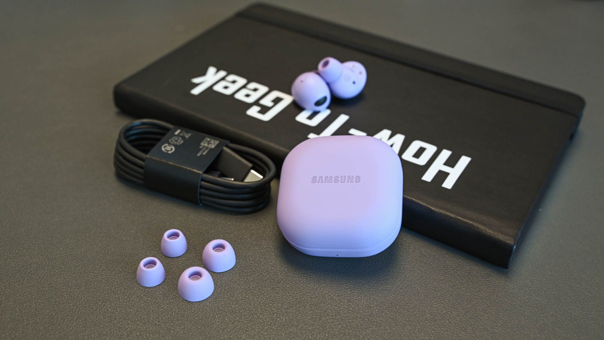The Galaxy Buds2 Pro and accessories on a notebook
