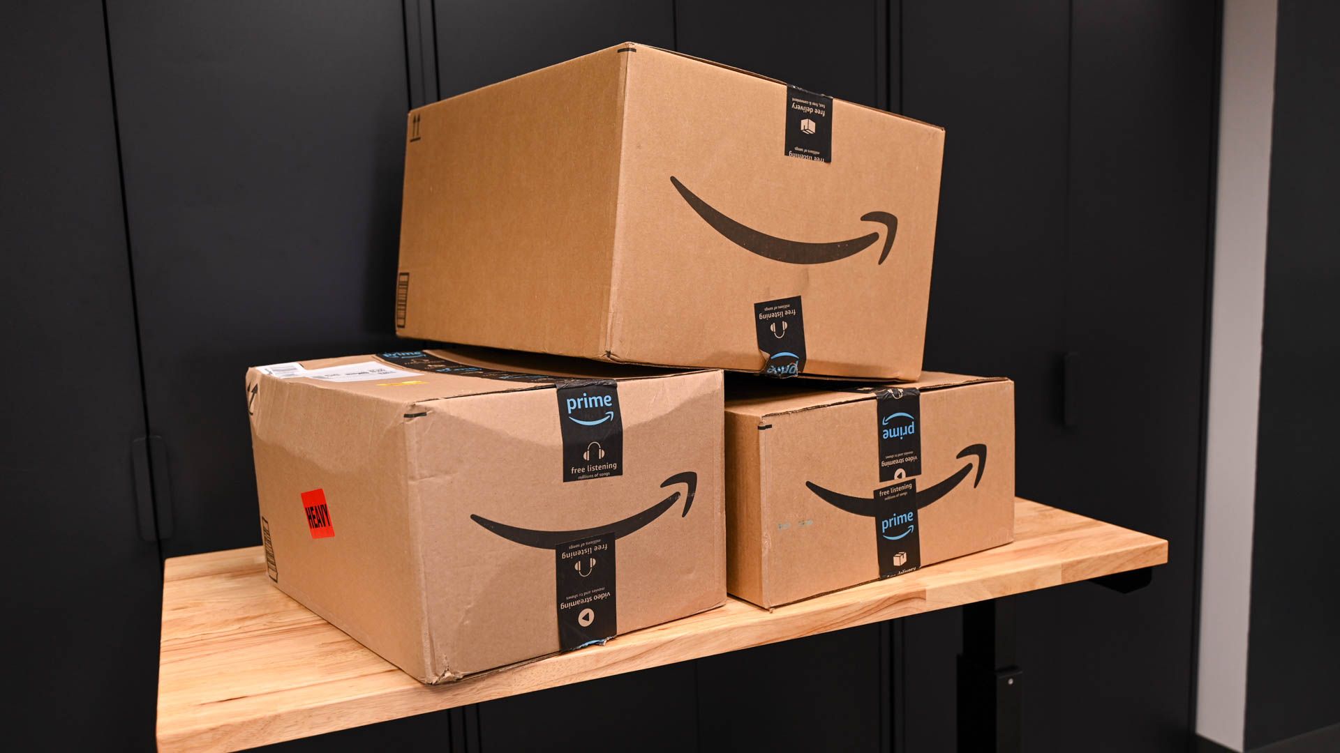 Amazon packages stacked on a workbench