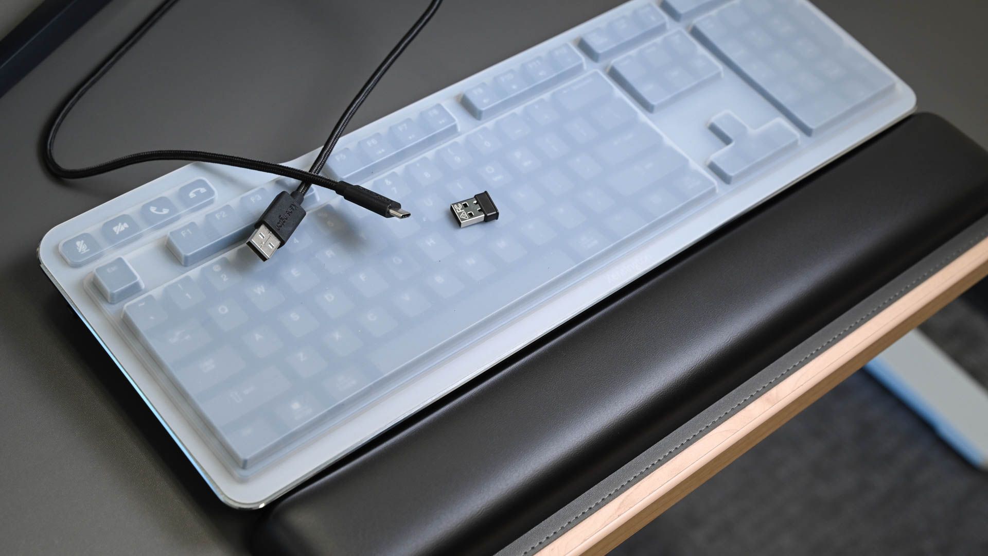 Kensington QuietType Pro keyboard on a desk with USB cable, dongle, and cover