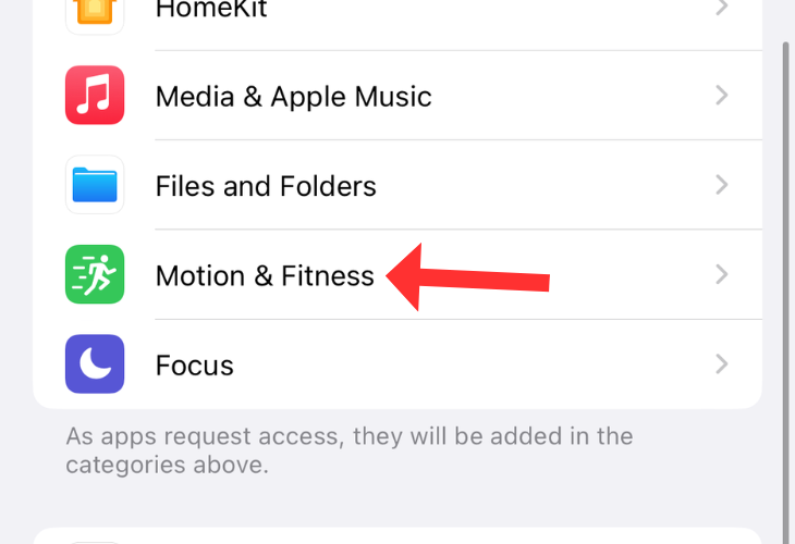 Privacy and security menu on an iPhone with an arrow next to the Motion & Fitness option