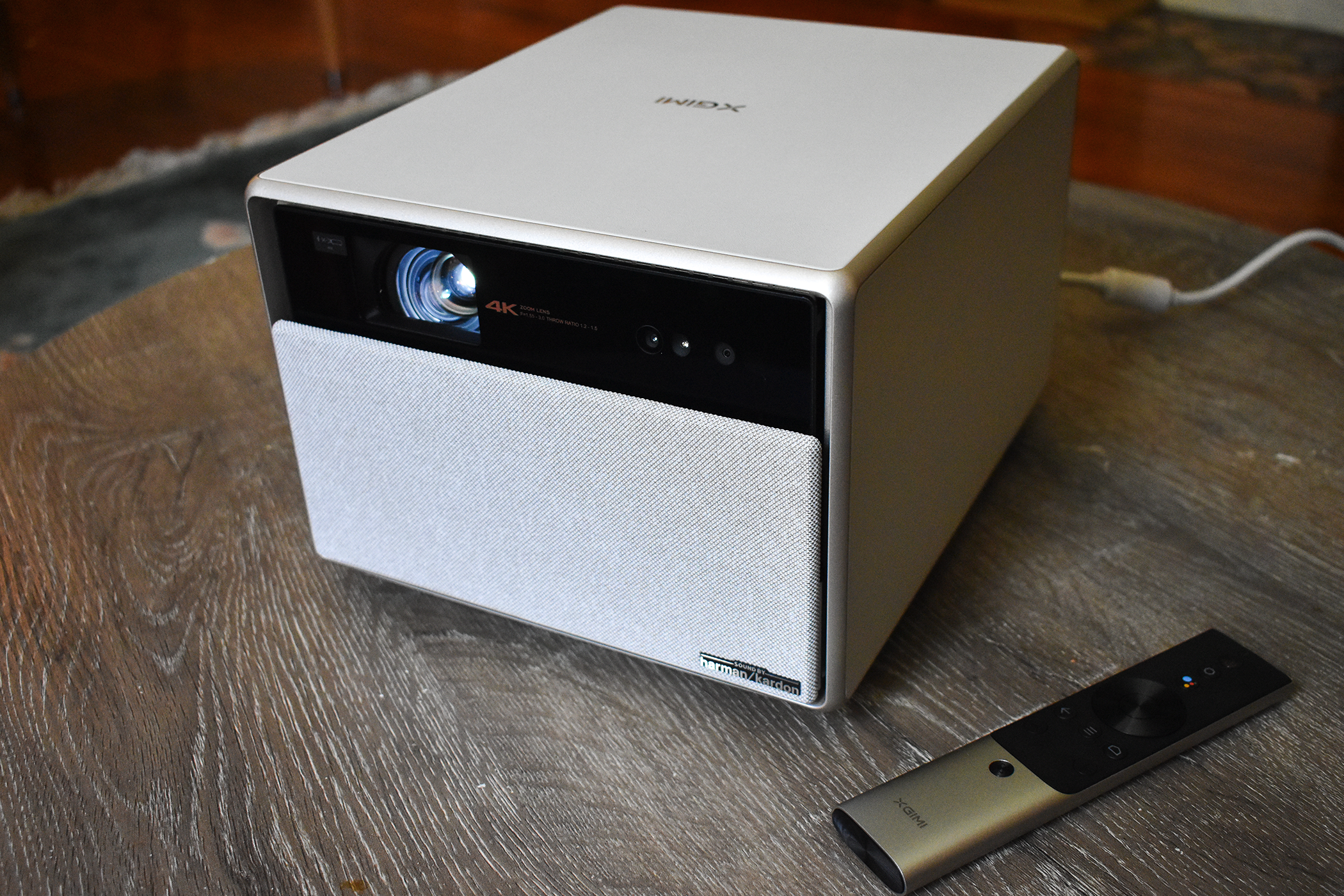 XGIMI Horizon Ultra projector sitting on a table next to its remote