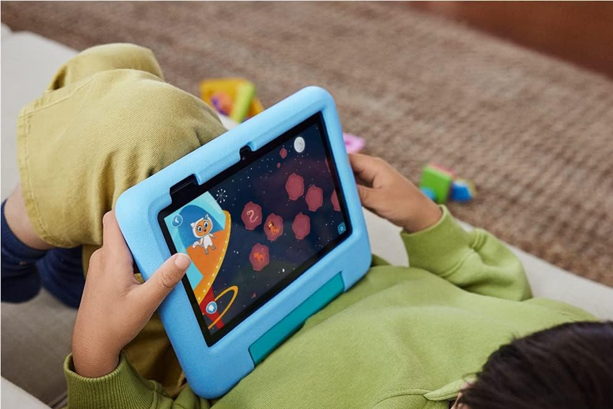 amazon fire 7 kids tablet in child's hand laying down
