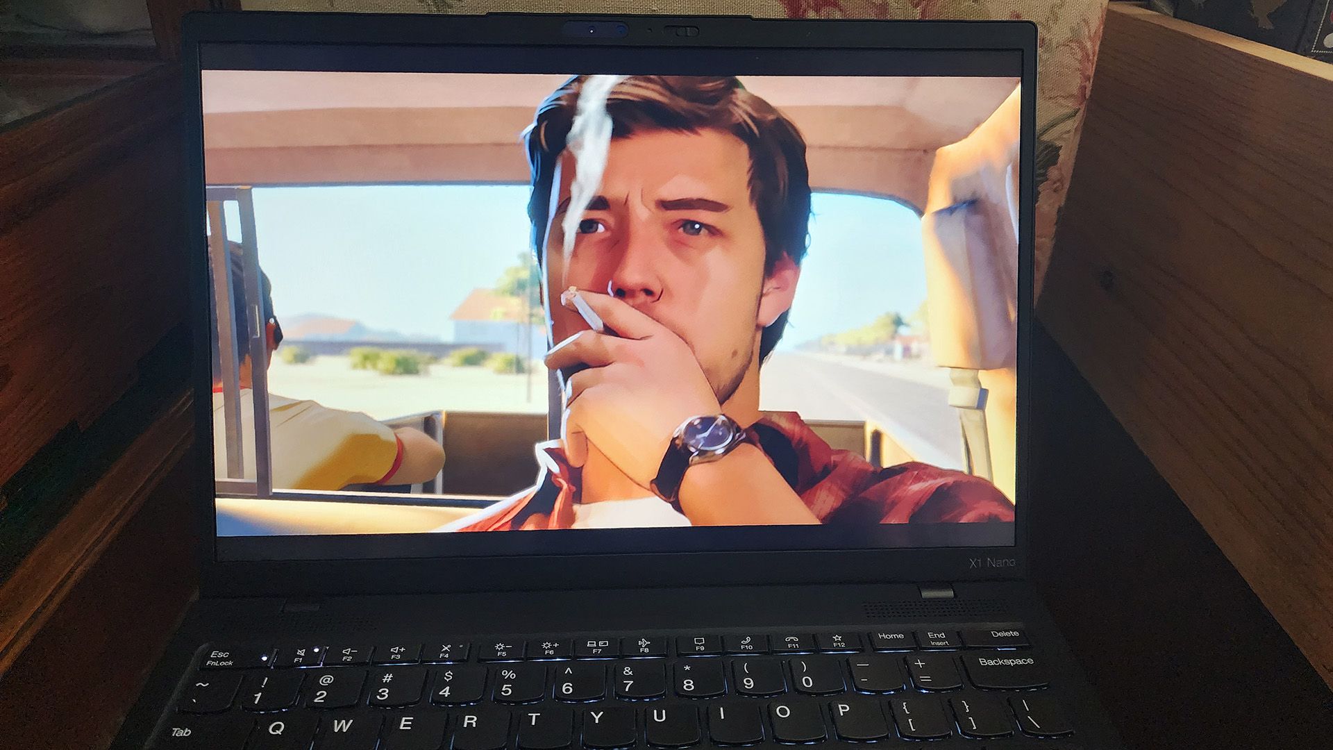 The Lenovo ThinkPad X1 Nano Gen 3 laptop playing a scene with a smoking man from the game 