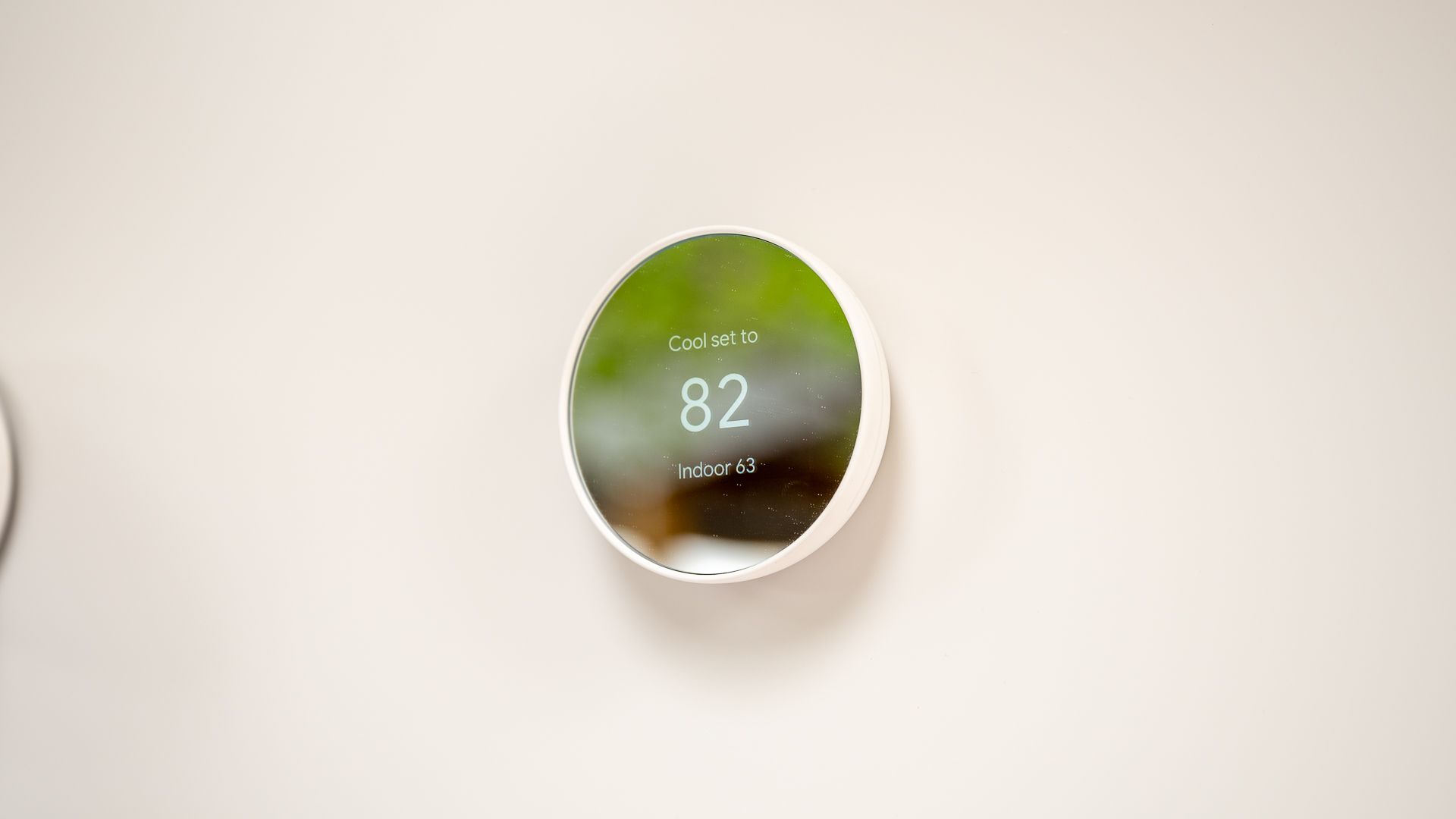 Google Nest Thermostat mounted on a wall