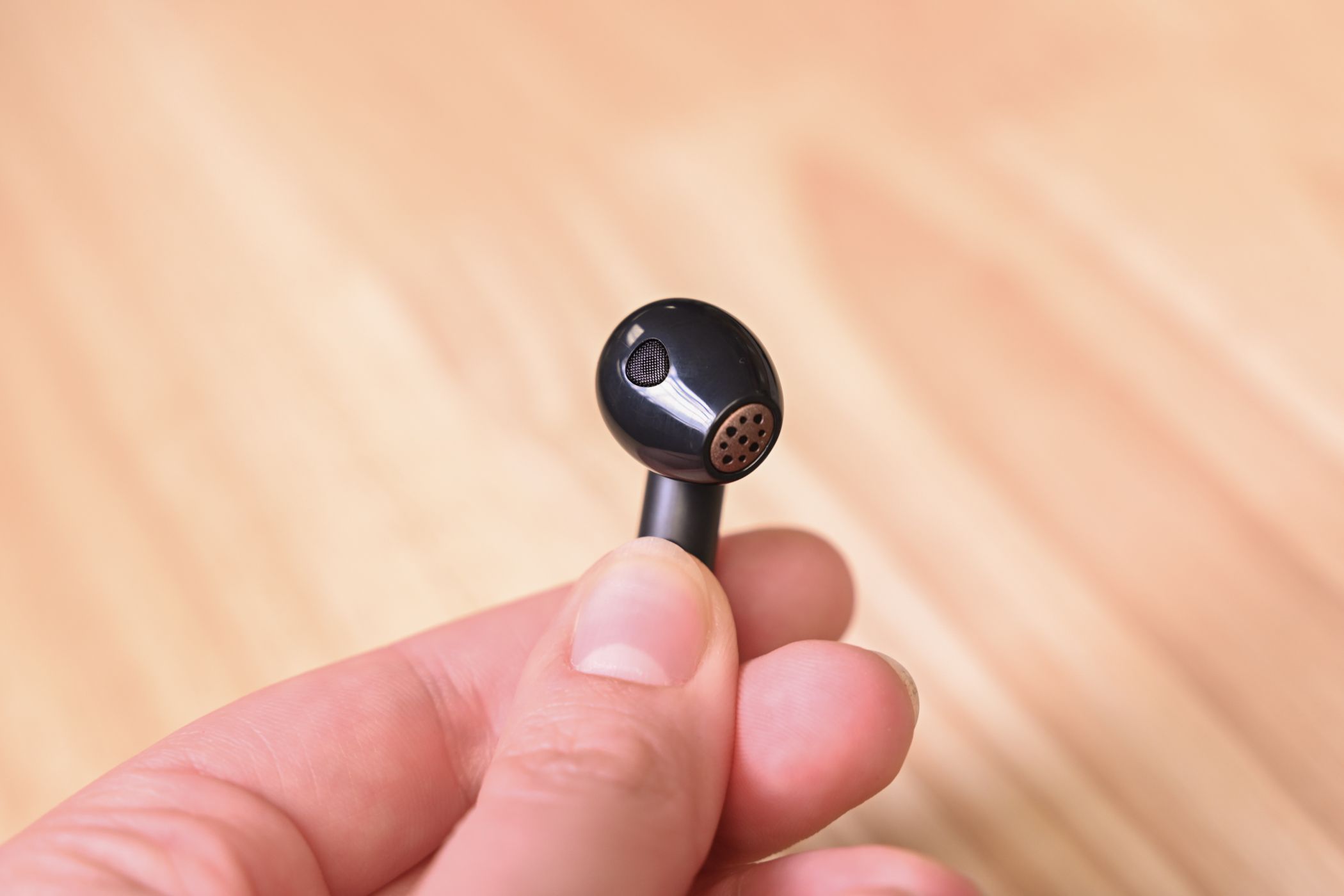 Person holding an SOUNDPEATS Air4 aptX Lossless Wireless Earbud