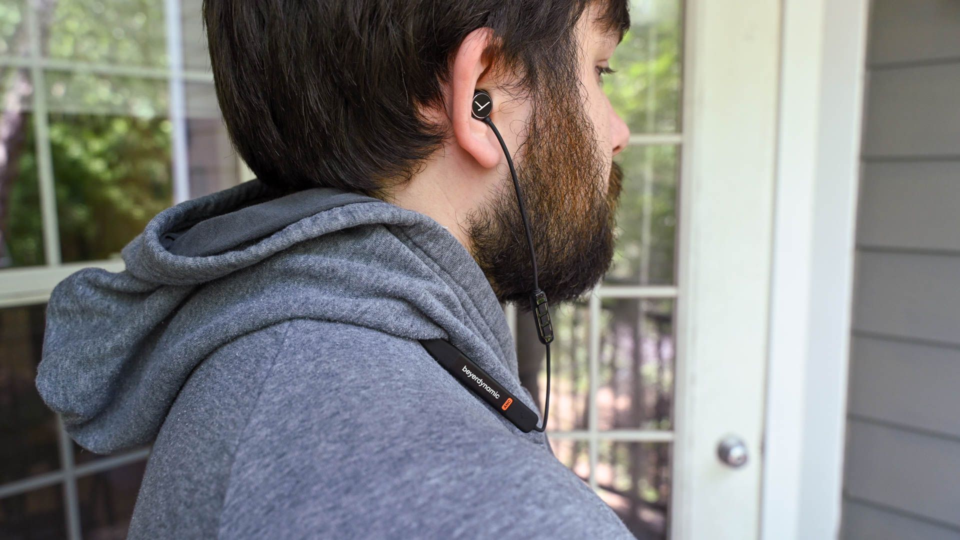 Person wearing the Beyerdynamic Blue BYRD ANC 2 around their neck with the earbuds in