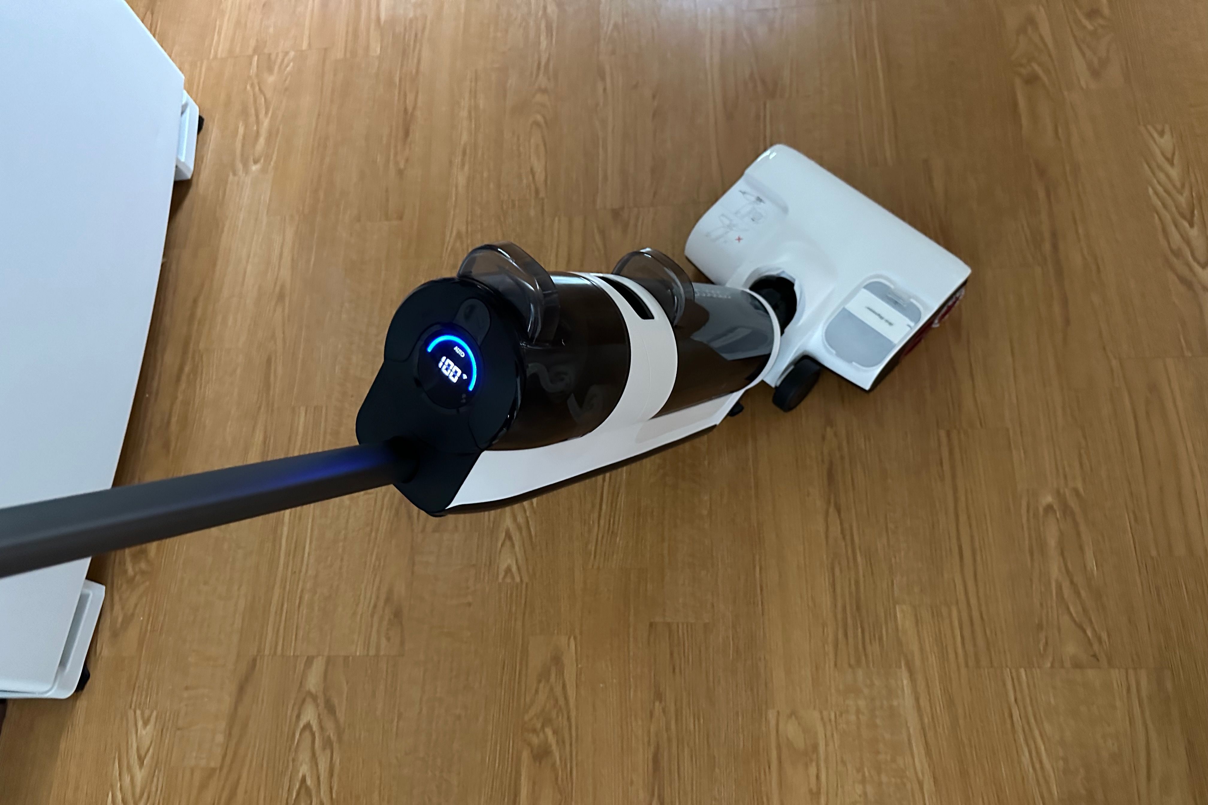 Showing a Roborock Dyad Pro in operation on a hardwood floor
