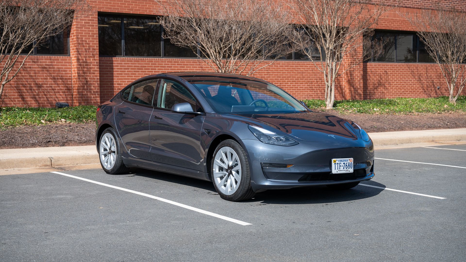 Side view of the Tesla Model 3 in a parking lot. 