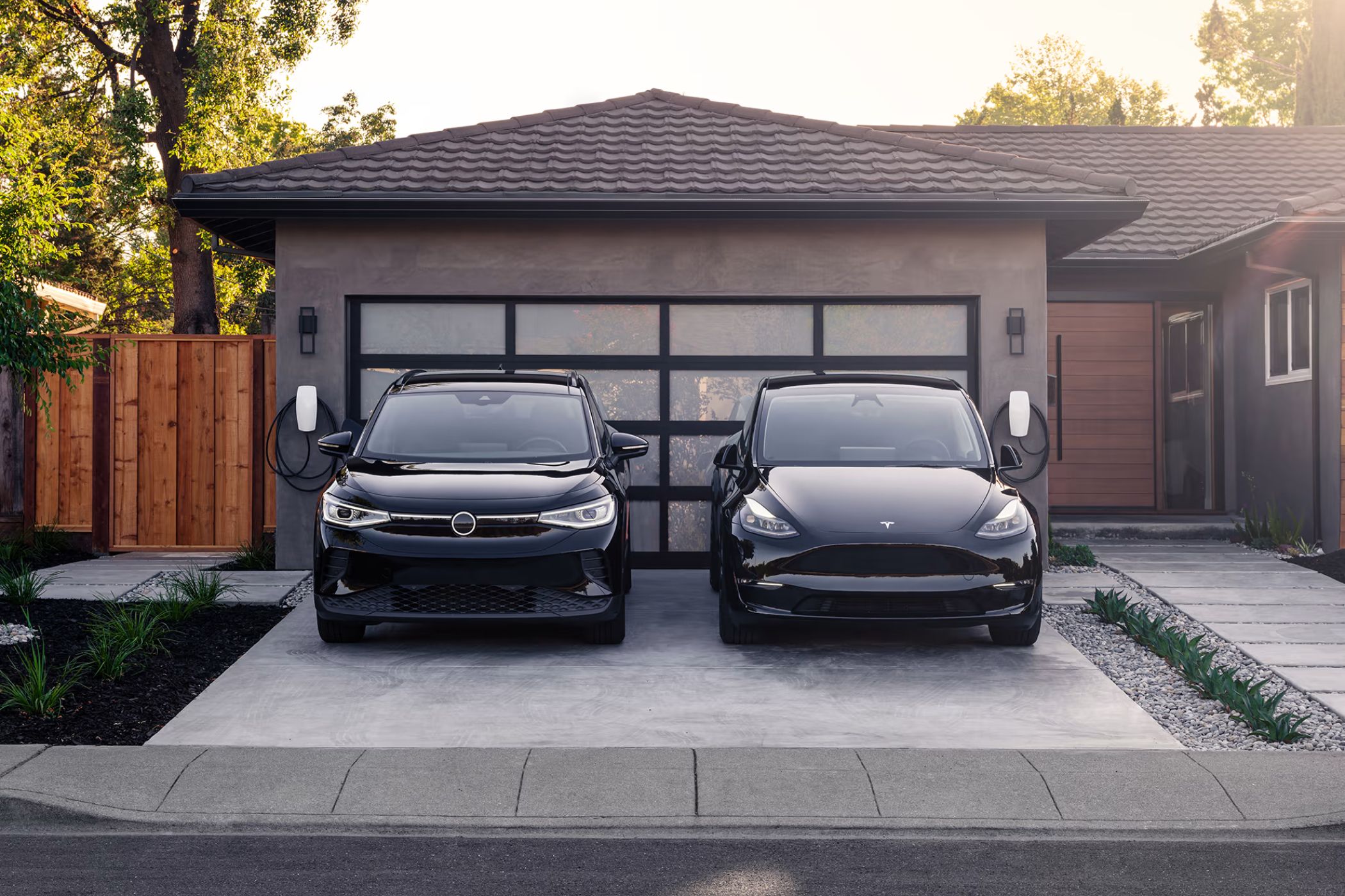Two different EVs using Tesla's new universal home charger.