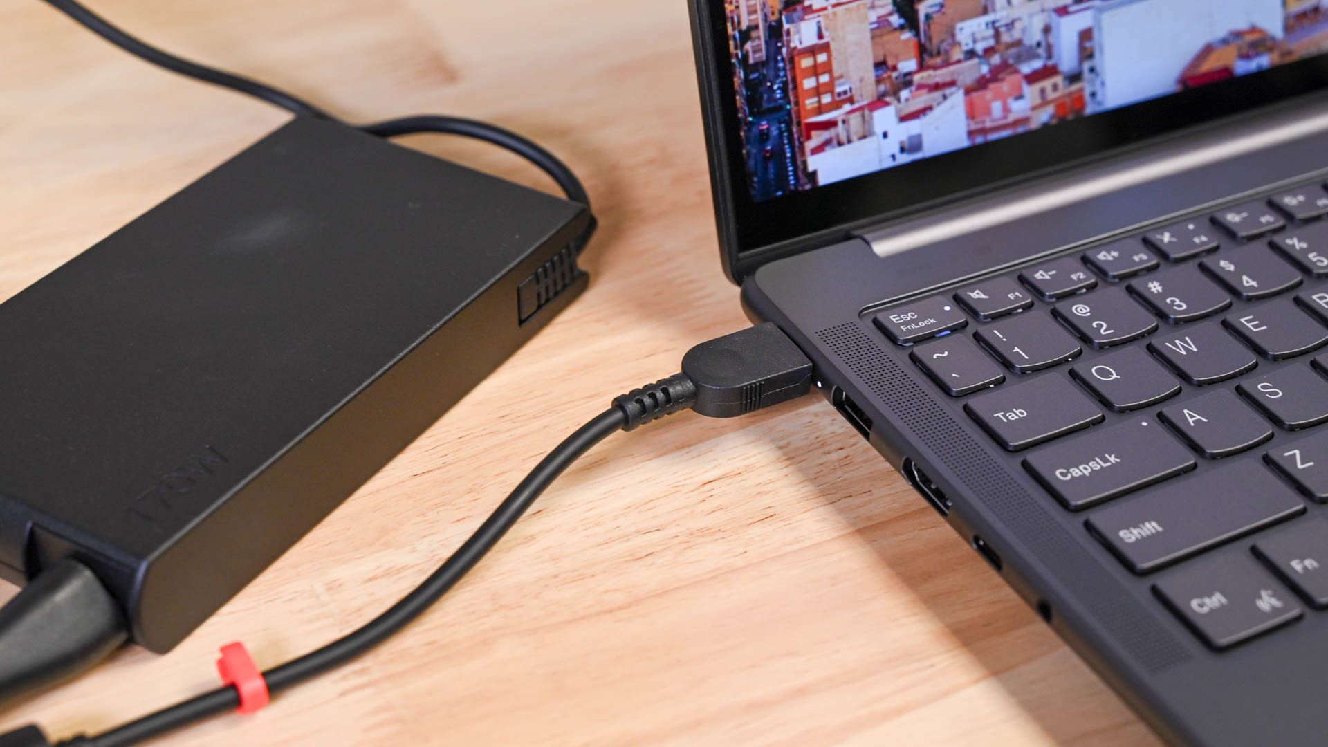 The power cable plugged into the Lenovo Slim Pro 9i 16-inch Gen 8.