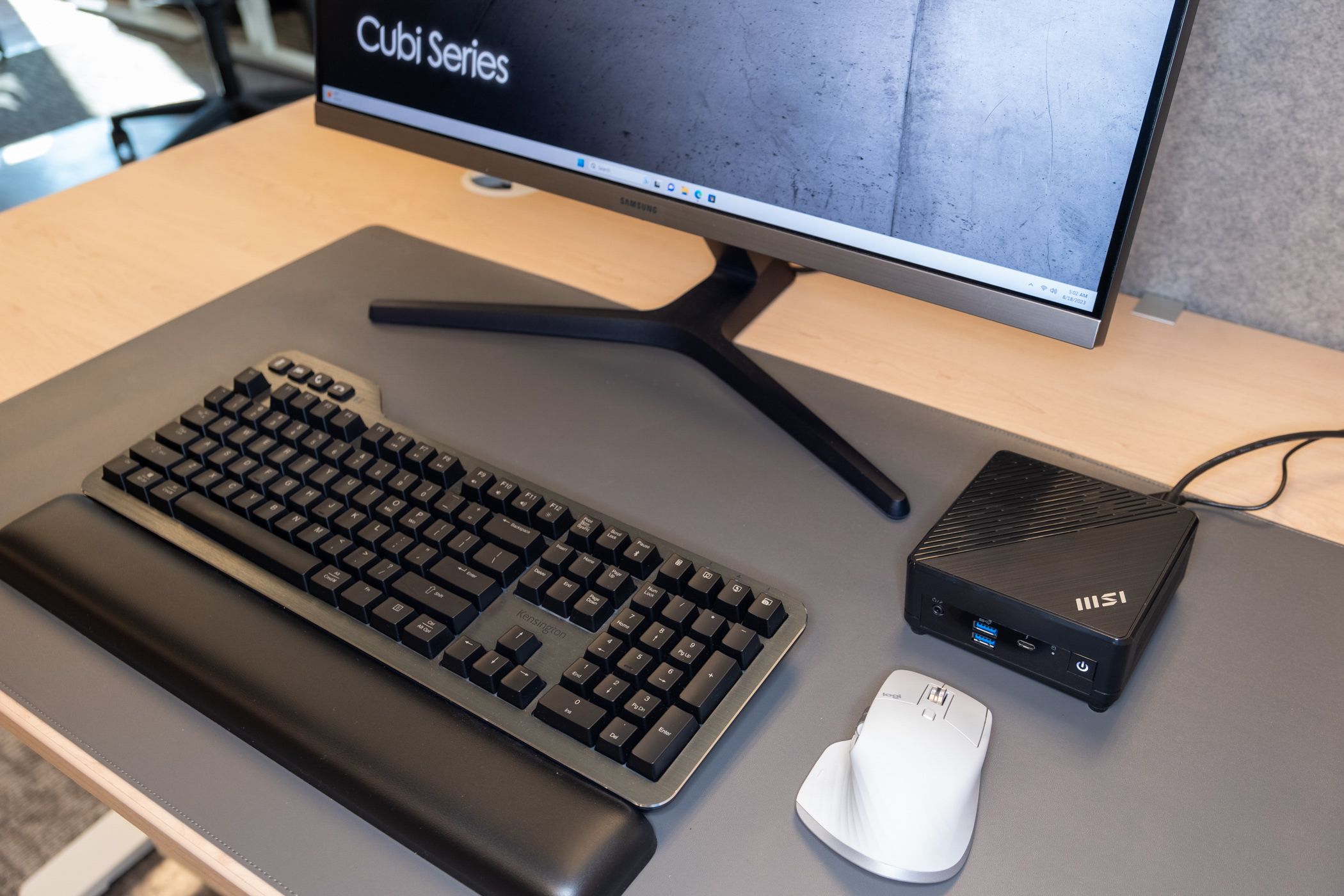 MSI Cube 5 12M behind a mouse and near a keyboard and monitor