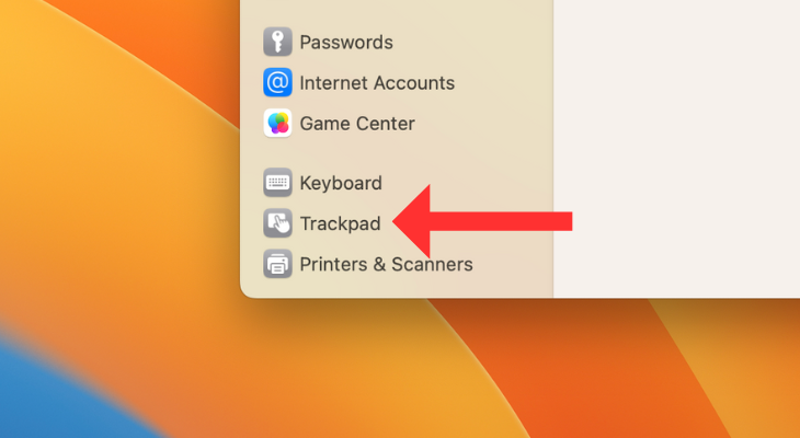 System Settings menu with an arrow next to Trackpad