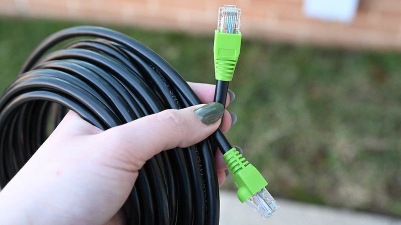 An Ethernet cable with green strain relief. 
