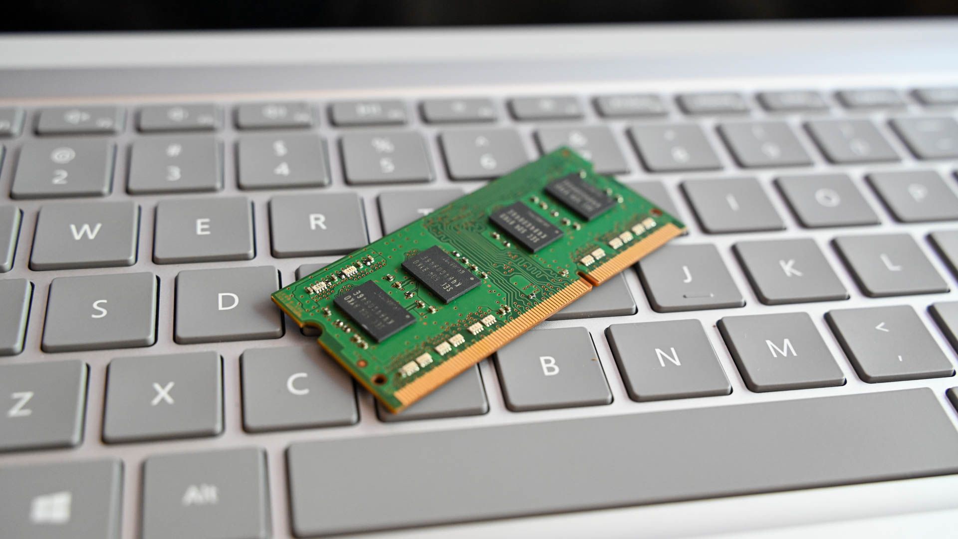 RAM stick sitting on a laptop keyboard