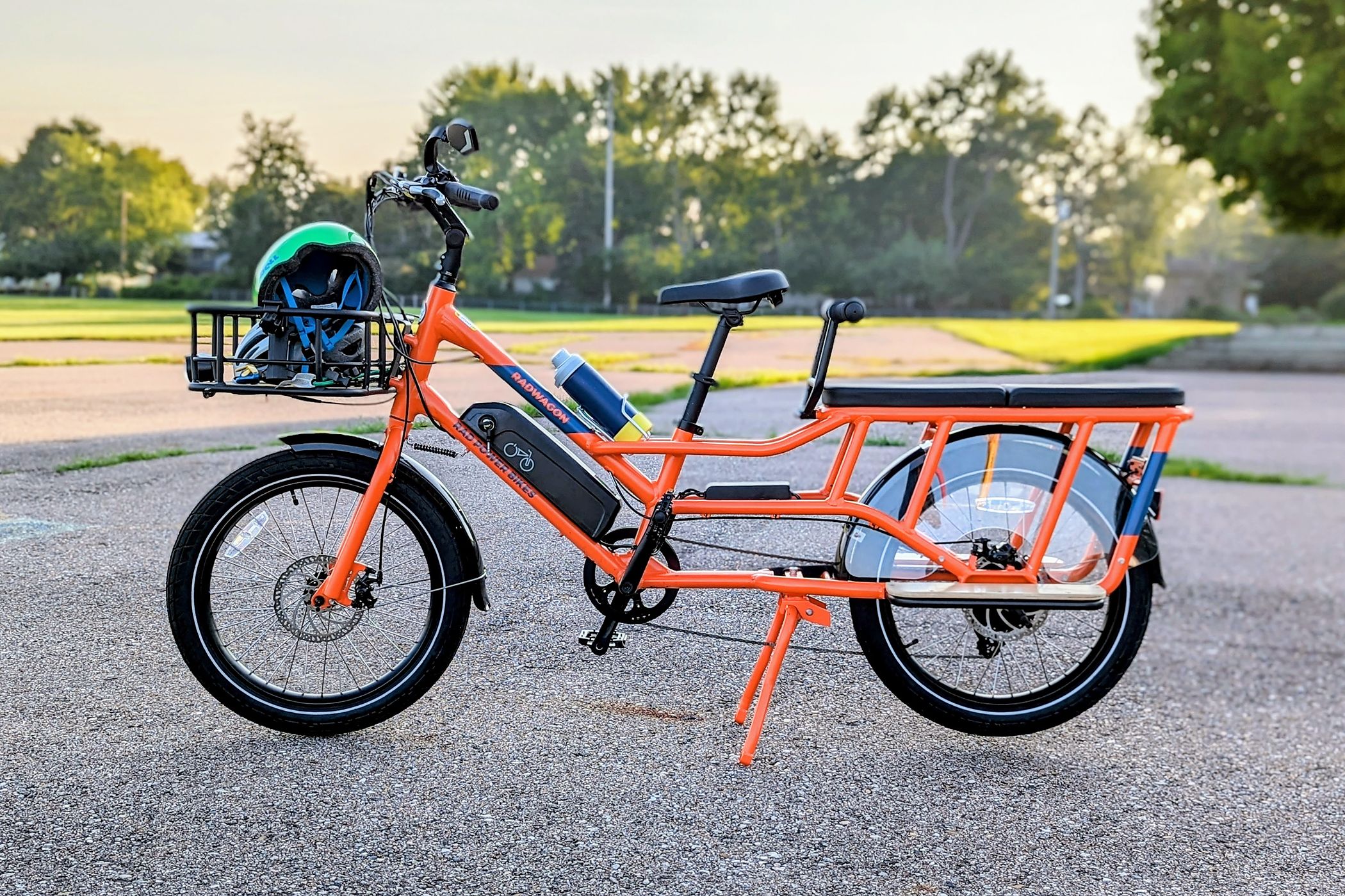 An orange Rad Power RadWagon 4 bike standing on concrete