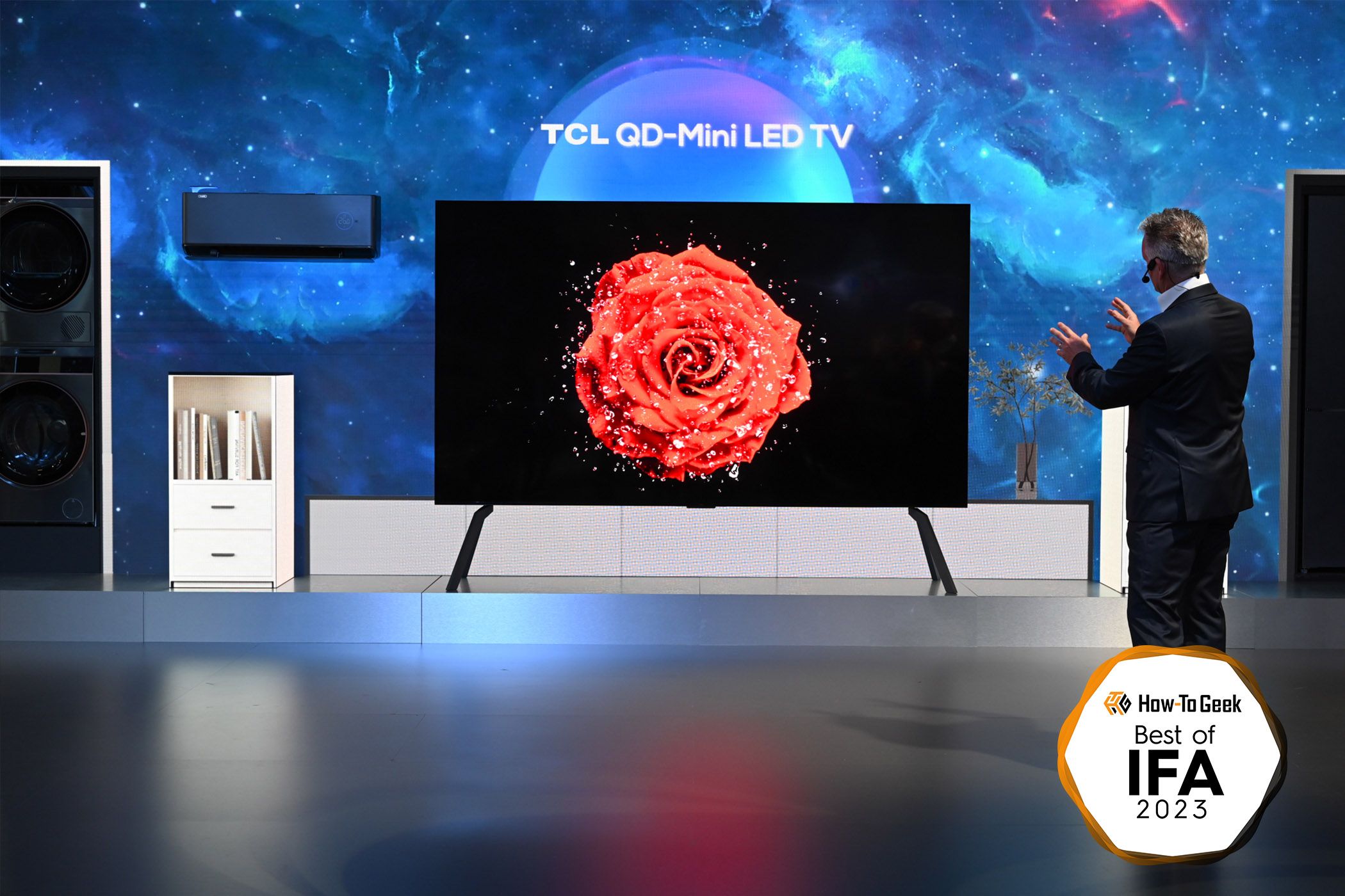 A man standing in front of a large TCL TV