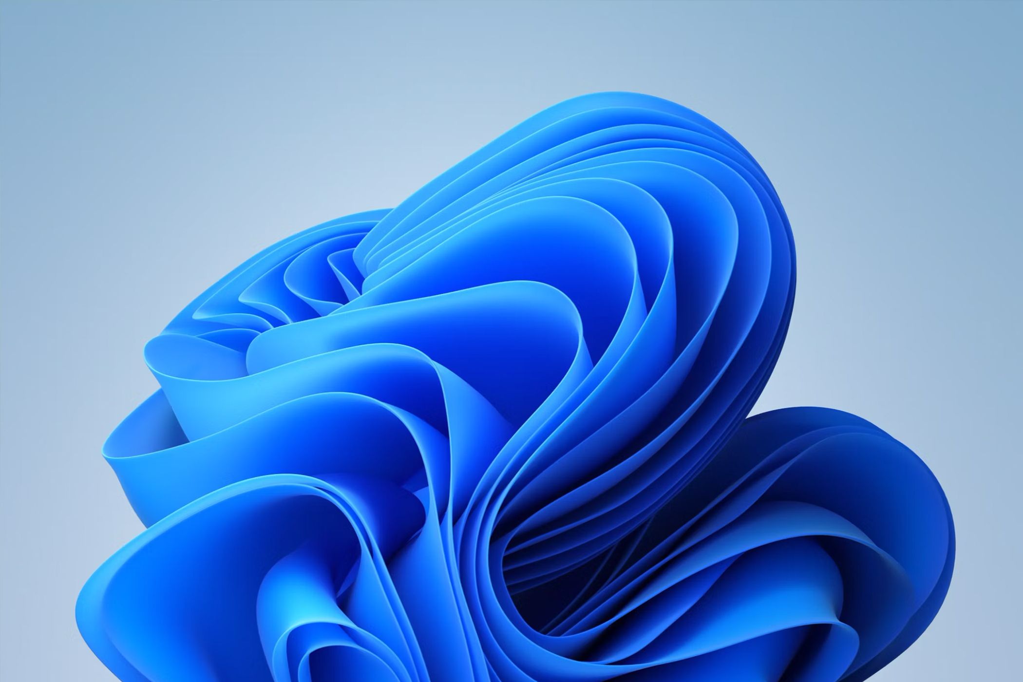 The default blue swirl pattern of the Windows 11 background.