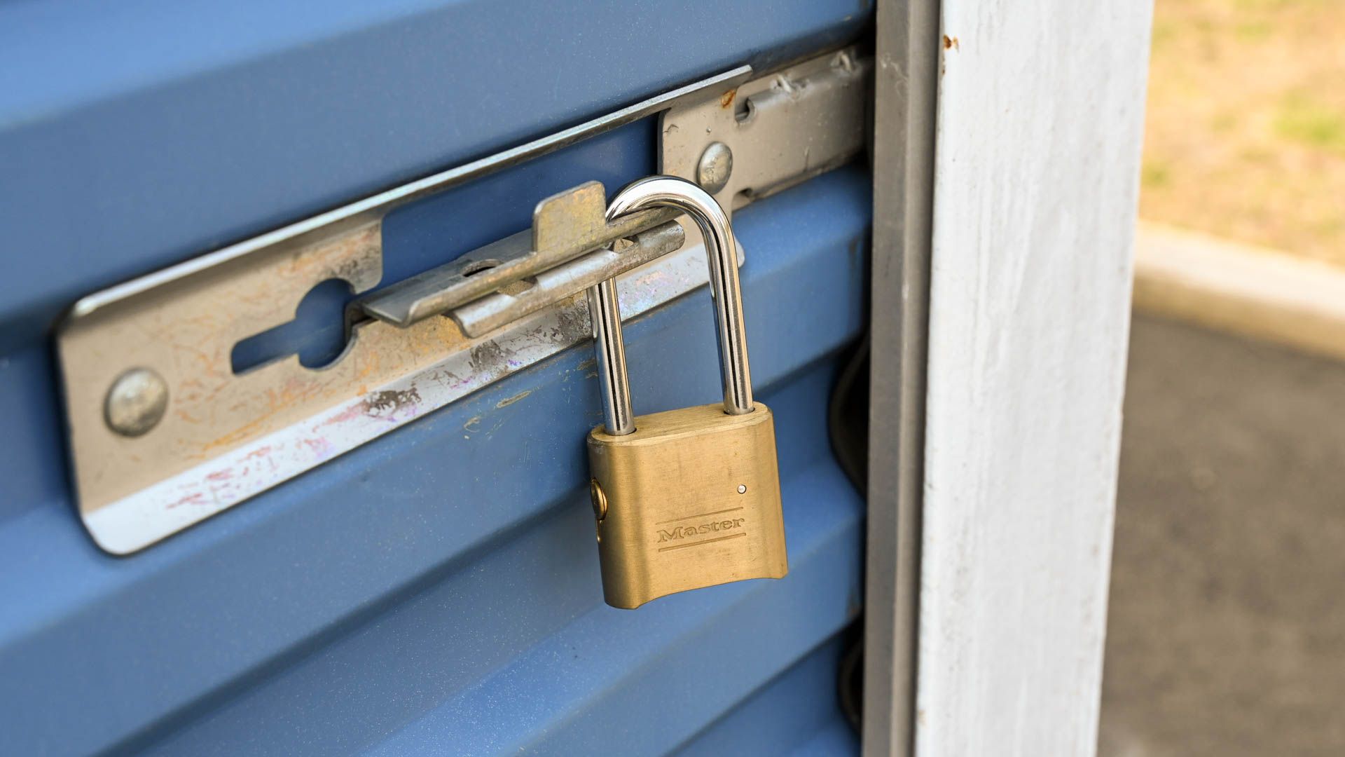 A master lock securing the latch on a storage unit