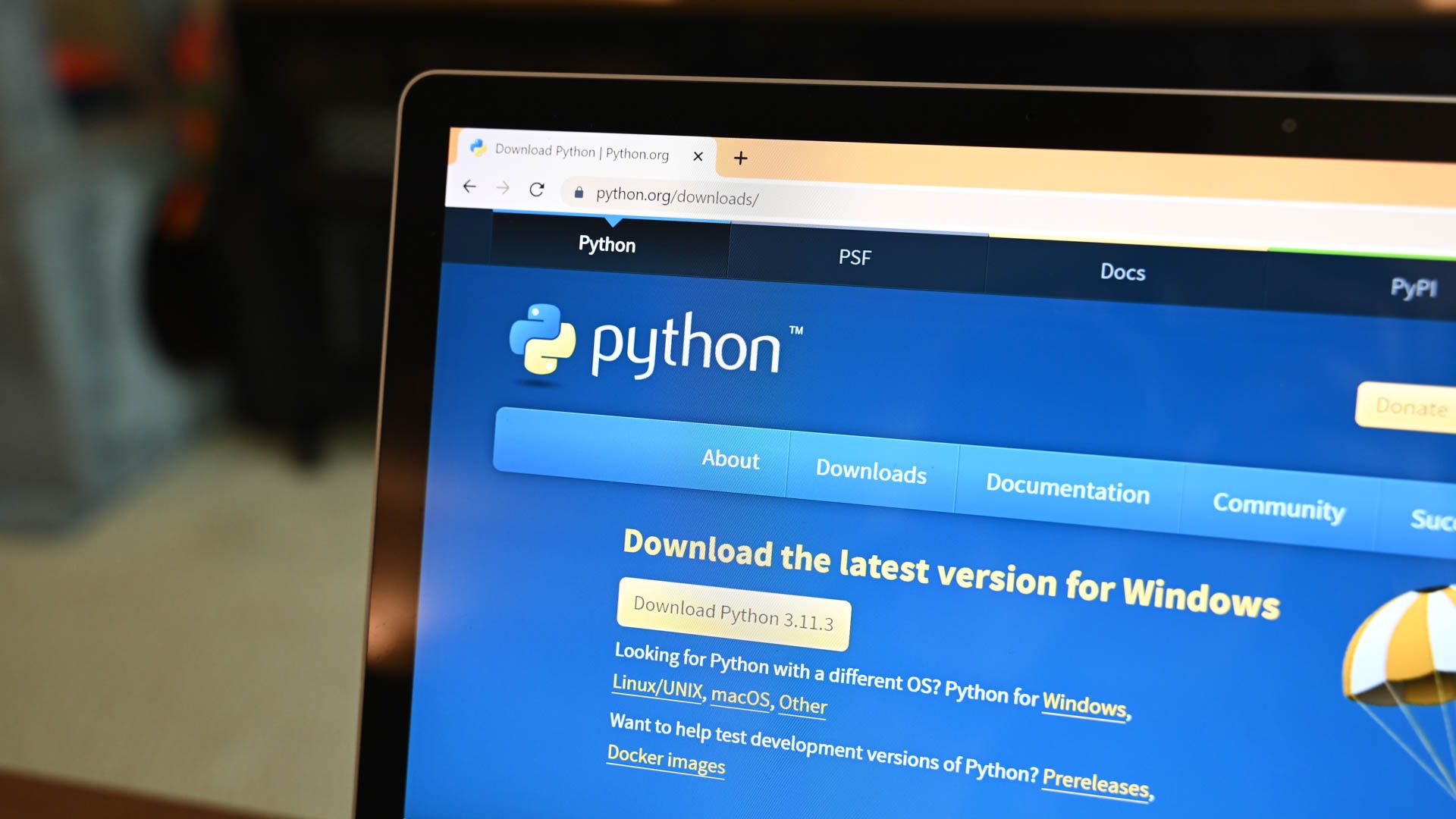 A laptop with the Python download webpage open on Chrome.