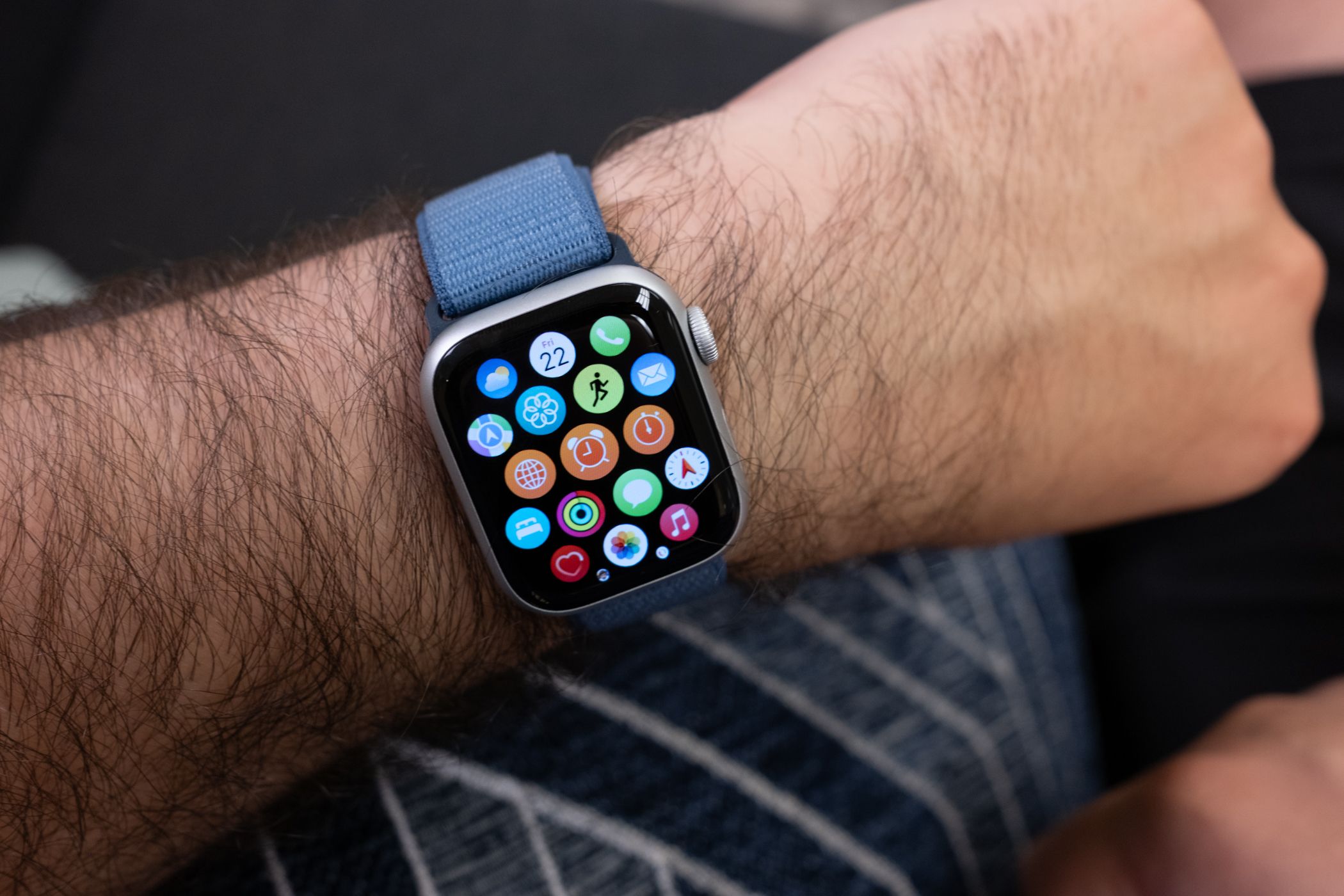 A person wearing an Apple Watch Series 9 with the App Menu being shown.