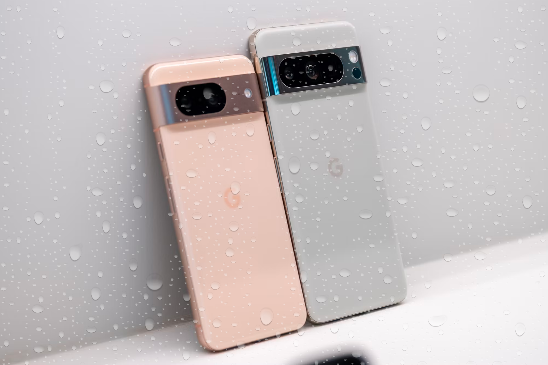 Pixel 8 and Pixel 8 Pro under water droplets