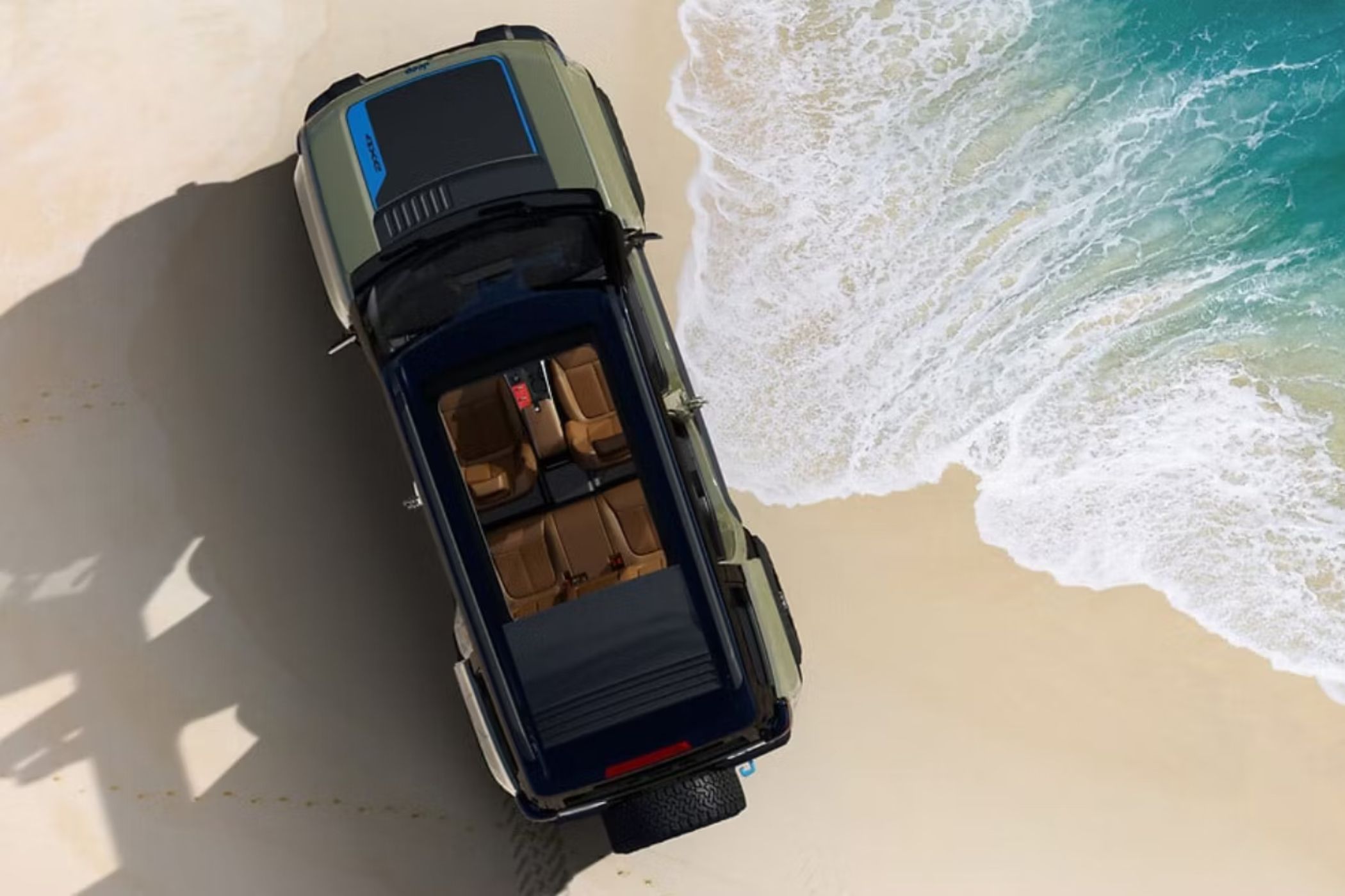 Jeep Recon EV top view with sunroof open on the beach.