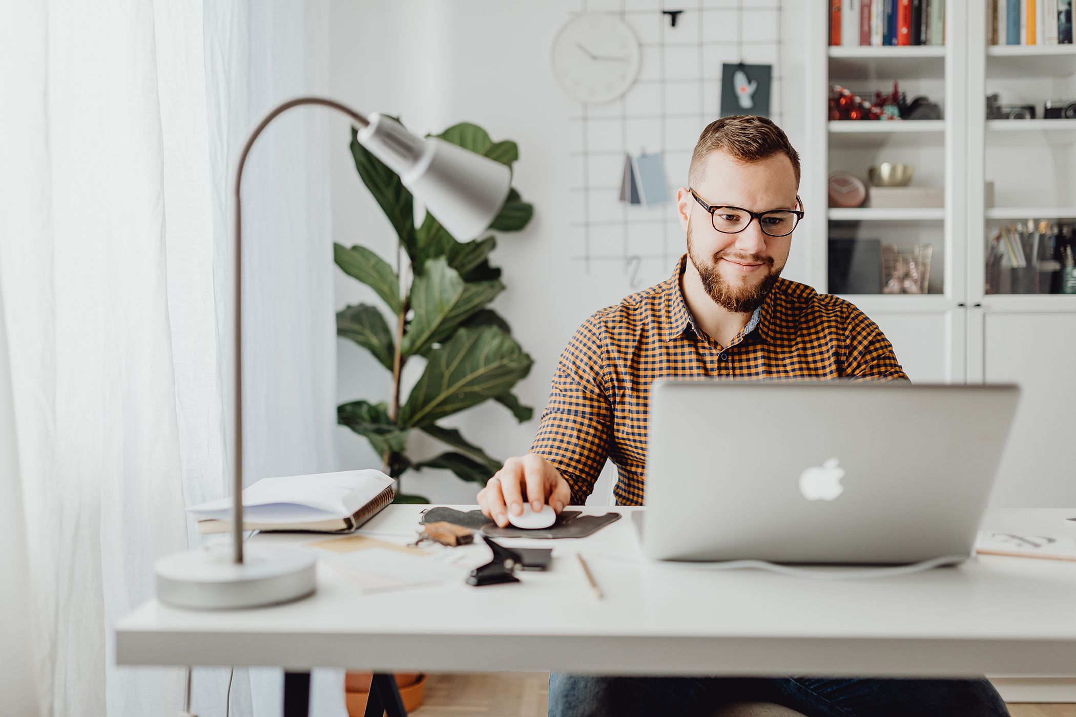 A man using a macbook in a home office