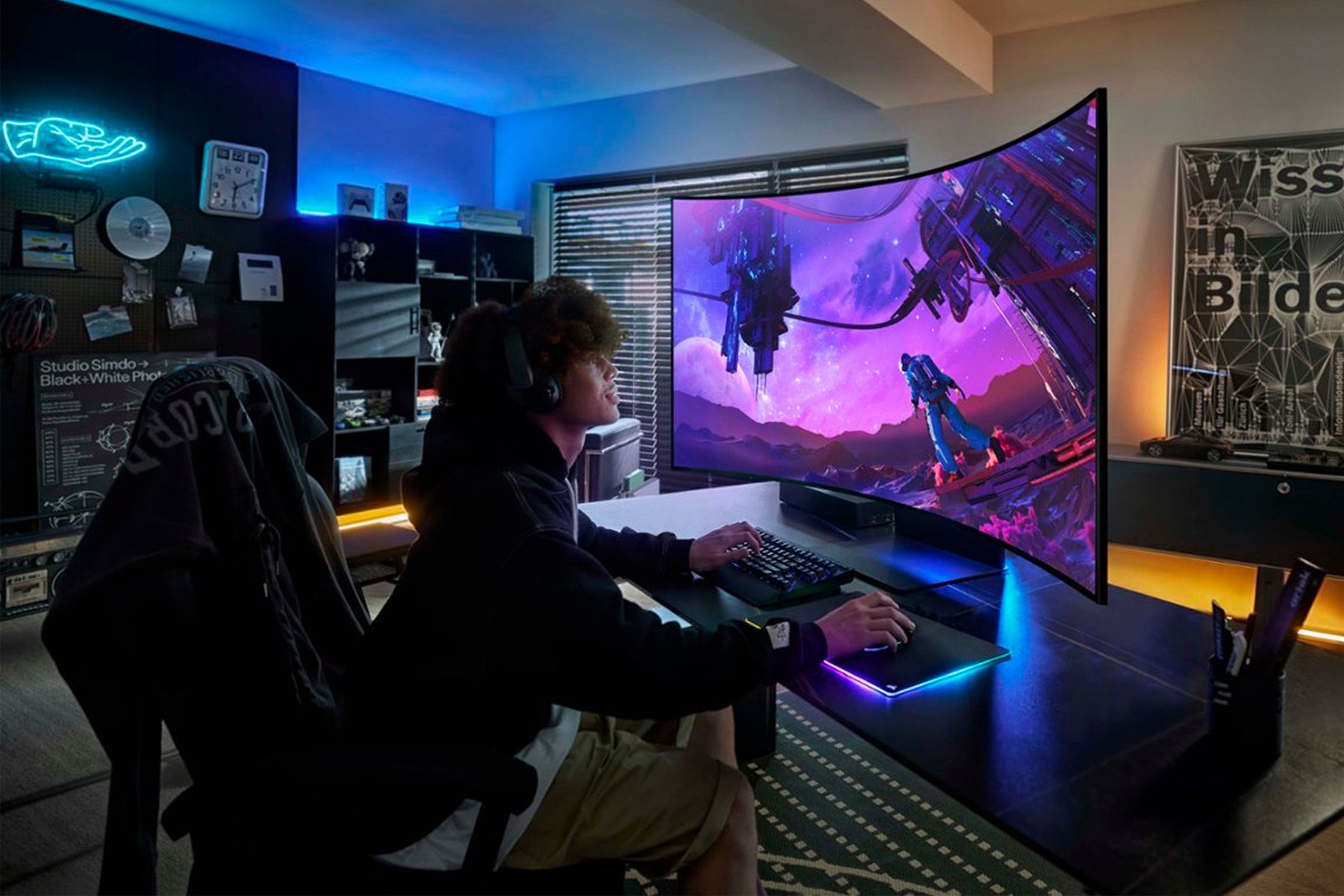 Person typing in front of a Samsung Odyssey Ark monitor