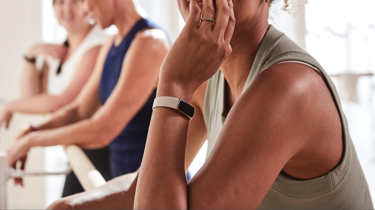 Young woman wearing a Fitbit Luxe Fitness and Wellness Tracker.