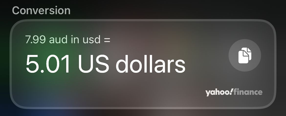 Converting $7.99 Australian to US Dollars in Spotlight on an iPhone.