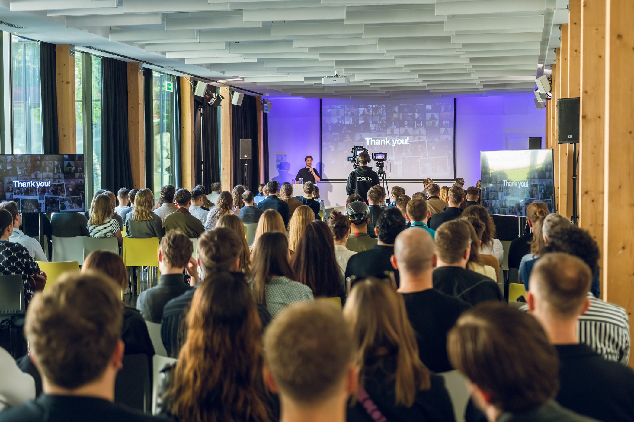 crowd of people in front of projector screen