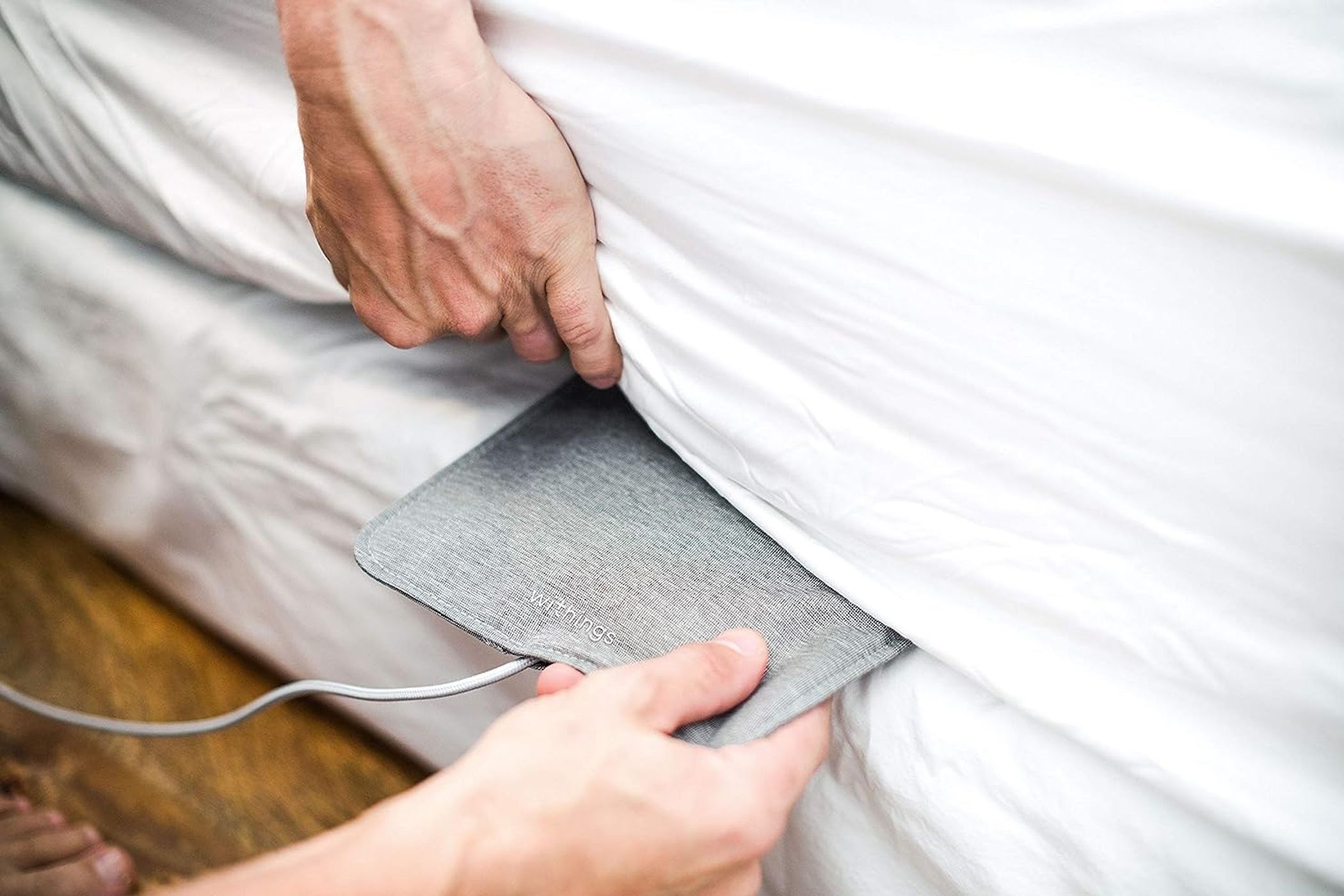 withings sleep pad being placed under mattress