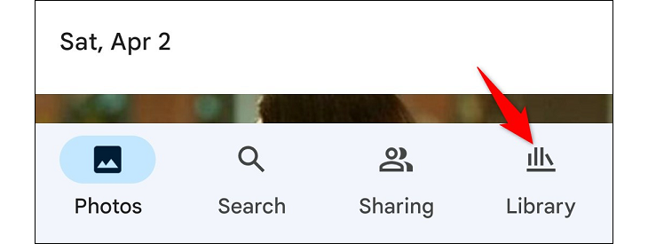 Screenshot of the bottom bar in Google Photos, arrow pointing to Library