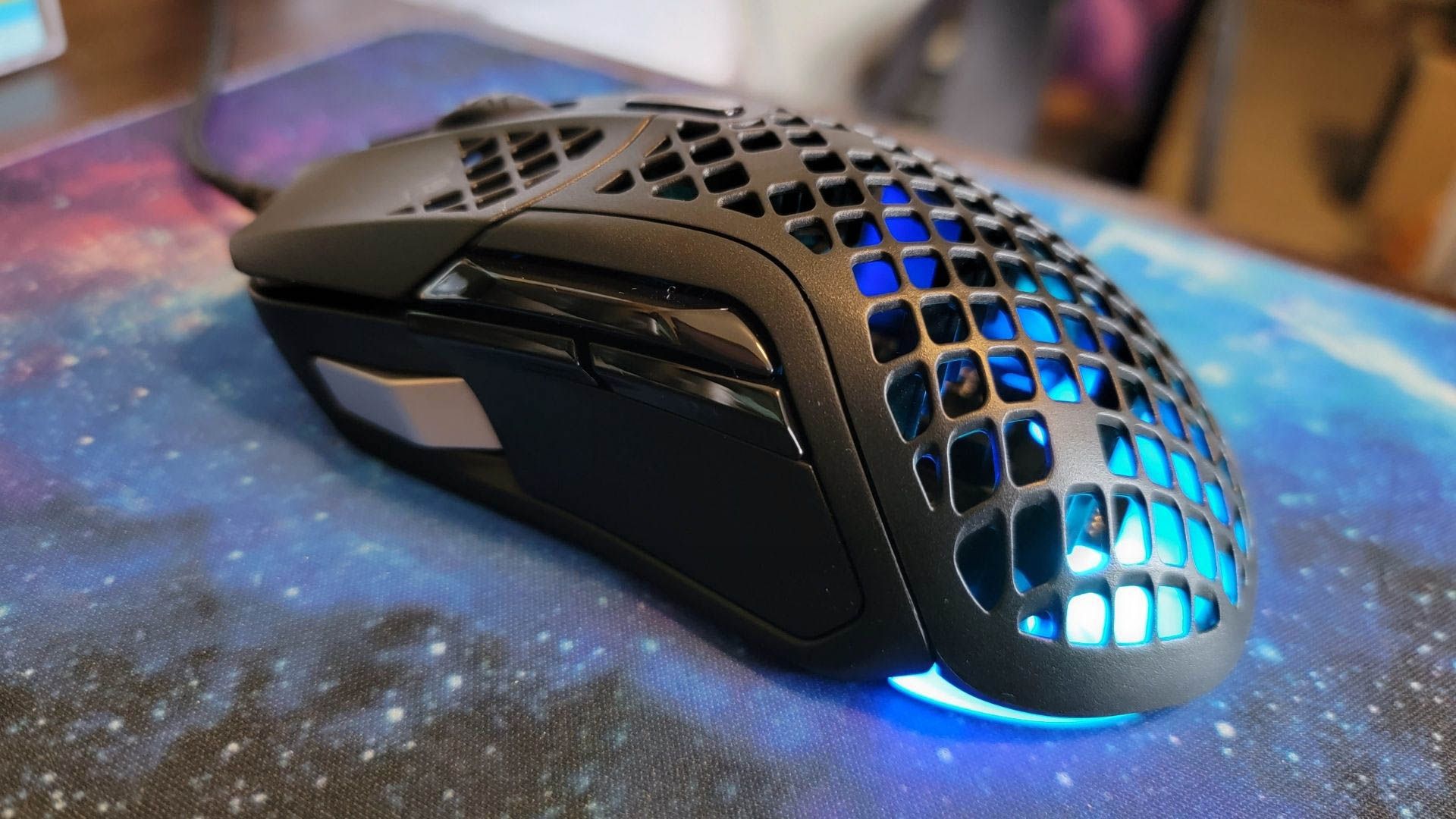 side shot of the steelseries aerox 5 gaming mouse with blue led light
