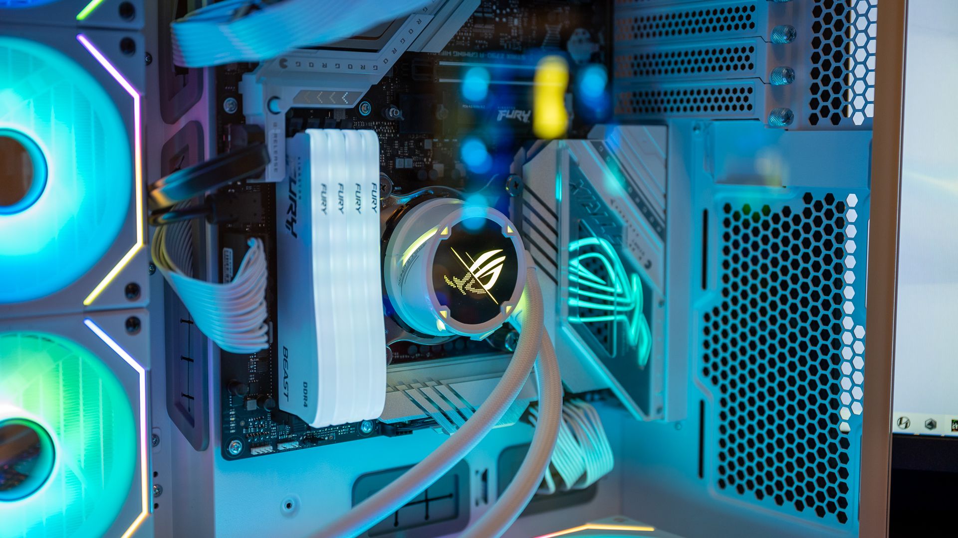 A gaming PC with an all-in-one liquid cooler and soft blue-green lighting. 