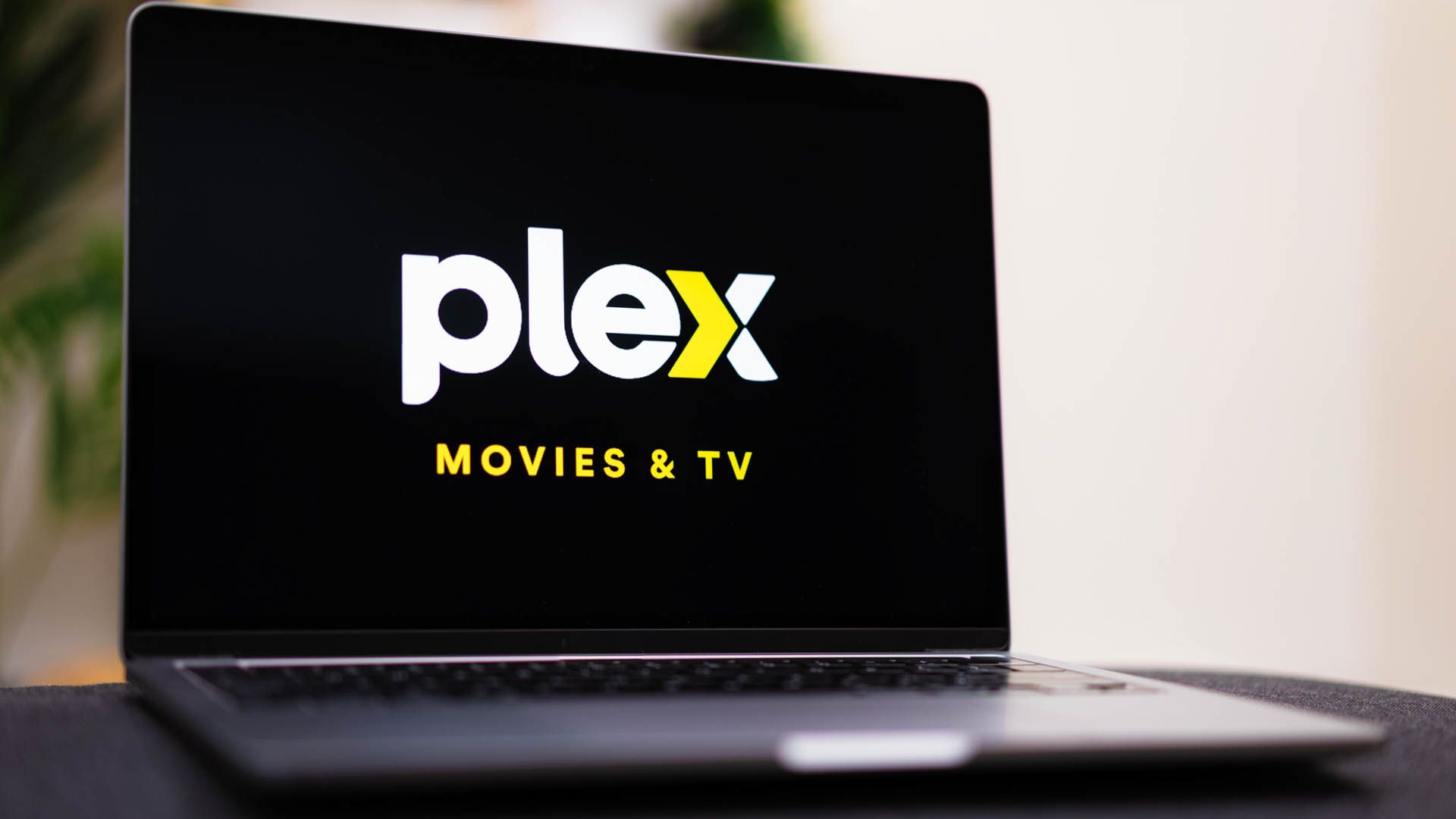 The Plex logo open on a laptop screen.