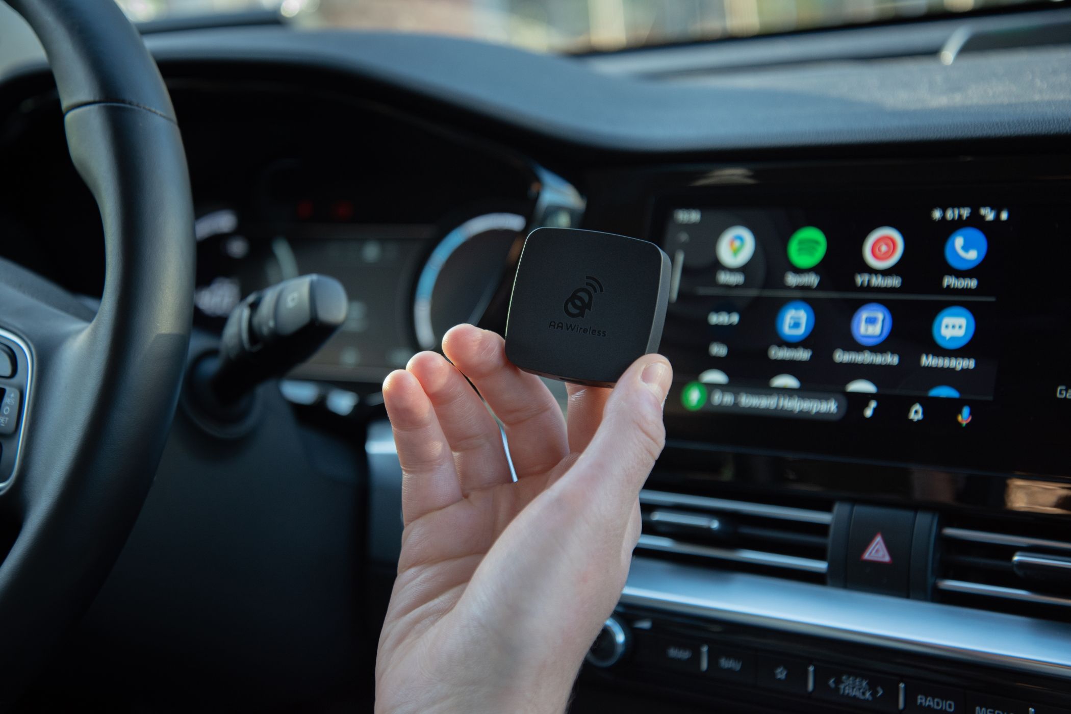 AAWireless Android Auto Adapter Being Held Inside of Car