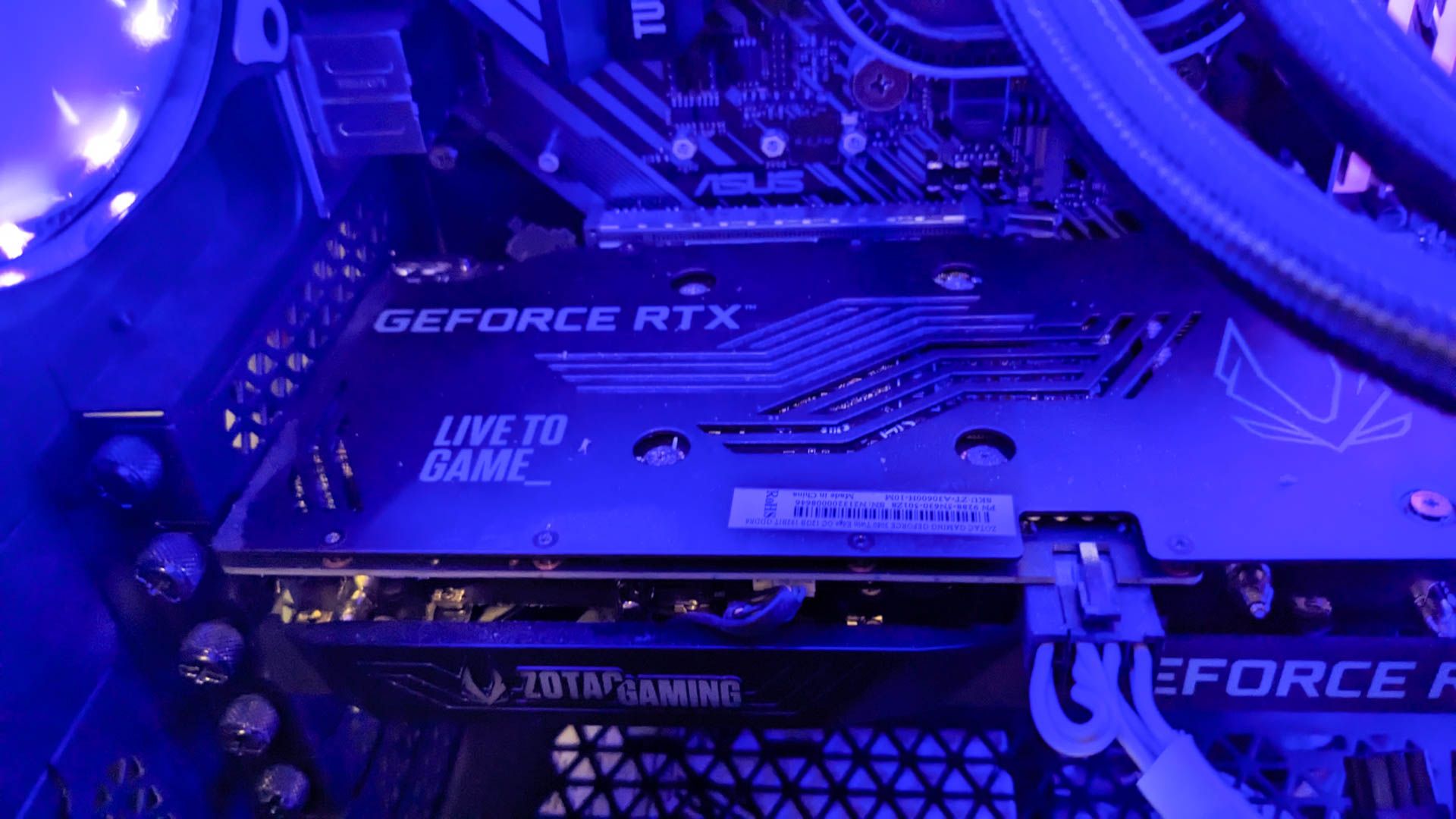 A Geforce RTX 3050 Ti GPU inside a computer tower under blue light.
